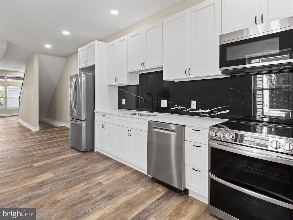 Welcome to 2903 Winchester Street, a fully renovated 4-bedroom, 3-bathroom home on Baltimore’s west side that delivers modern finishes without losing its city character.

This property is eligible for up to $10,000 through Baltimore City’s Vacants to Value Booster program (buyer must meet DHCD guidelines).

The open-concept layout connects the living, dining, and kitchen areas for practical everyday living and easy entertaining. Luxury vinyl plank flooring runs throughout, giving the home a clean, durable, cohesive look.

The kitchen is finished with stainless steel appliances, generous cabinetry, and contemporary touches that make it both functional and inviting. Off the rear, a 200-square-foot deck extends your living space outdoors, overlooking a private fenced yard ideal for gatherings, pets, or quiet evenings. Washer and dryer are included.

Upstairs, the spacious primary suite features a private en-suite bath. With three full bathrooms total, the layout offers flexibility for families, guests, or work-from-home needs.

Renovated top to bottom and move-in ready.