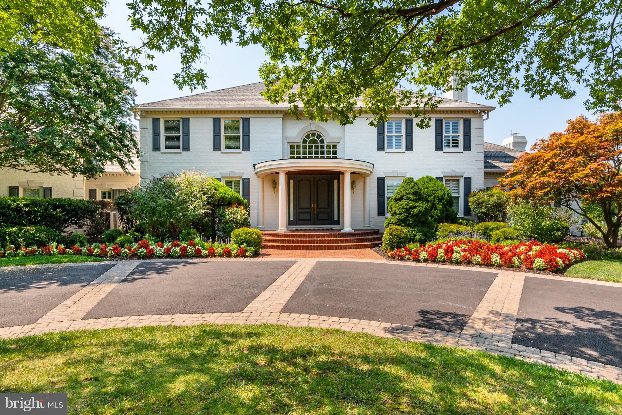 Welcome to 8929 Harvest Square Court, a stunning solid brick home enclosed on a private two acre estate. This extravagant seven bedroom, nine full bathroom home is perfectly situated on a quiet cul-de-sac with a gated entrance and fenced yard. Complete with over 17,000 square feet of fully finished space, this home offers a pool, indoor basketball court, movie theater, fitness center and a newly renovated high design gourmet kitchen.
Enter through the oversized solid wood doors with transom side windows into the grand marble foyer featuring art niches and elevated ceilings. The main foyer accesses the powder room and conveniently connects to the primary suite. The primary bedroom showcases two bathrooms and three custom designed walk-in closets. The generously sized dining area is perfectly wrapped in chair rail molding and highlights an art deco ceiling fixture with a layered marble floor design. The dramatic living room features eighteen foot vaulted ceilings, offering stunning views of the pool and yard through the floor-to- ceiling windows. A nearby cozy family room attaches to the living area and a designer buffet connects the dining room and kitchen. The state of the art kitchen is packed with high design and has everything you could possibly need for a gourmet cooking experience. The kitchen is an epicurean dream with the countertops and backsplash wrapped in marble, hand-made wood cabinetry, and dual islands offering an ideal setup for entertaining. The kitchen showstoppers are the new oversized side-by-side sub-zero refrigerators, three ovens and the eight-burner gas range stove. There is double the luxury with dual dishwashers, warming drawers, cooling drawers, microwaves and sinks. A mudroom equipped with a washer, two dryers, walk-in pantry space and powder room, connects to a three car garage with an electric charger and built-in cabinetry. Around the corner you will find a second three car garage and an additional bedroom complete with an en suite bathroom, closet space and sliding doors to the patio. The main level rear hallway accesses a top floor apartment that features a bedroom and living space with cathedral ceilings and a kitchen wrapped in cherrywood cabinets with granite countertops, dishwasher, refrigerator, and dual basin sink. An additional dedicated staircase leads to the upper level office that encircles the back corner of the home. With custom wall-to-wall carpet, this space is complete with a built-in desk and cabinets, mounted TV, living area, beverage refrigerator and a powder room. A modern staircase with a decorative runner, glass dividers and black and gold newells lead you to the open stairwell connecting to four bedrooms. The hall bathroom includes an oversized modern soaking tub, dual vanity, and quartz countertops. Wall sconces and recessed lighting can be found in the hallway that also provides attic access. The opportunities for fun are absolutely endless in this lower level! This level offers lavish space for entertaining, exercising, gaming and lounging. The well designed indoor basketball court rivals any professional gymnasium. The home theatre features custom leather seating for eleven or more. The fitness center highlights everything you could dream of for an at-home gym. An additional entertainment option is the bar and kitchen area which features a refrigerator, ice maker, beverage cooler and dishwasher. The backyard has everything you can think of from an outdoor pool and hot tub, garden shed, shuffleboard, grass sport court, and oversized gazebo for covered cooking and dining. The privacy this lot offers in such an incredibly convenient location, just minutes away from I-495 and I-270, Potomac Village, Cabin John Mall and Wildwood Shopping Center cannot be beat. With all this home has to offer, don’t miss the opportunity to make it yours!