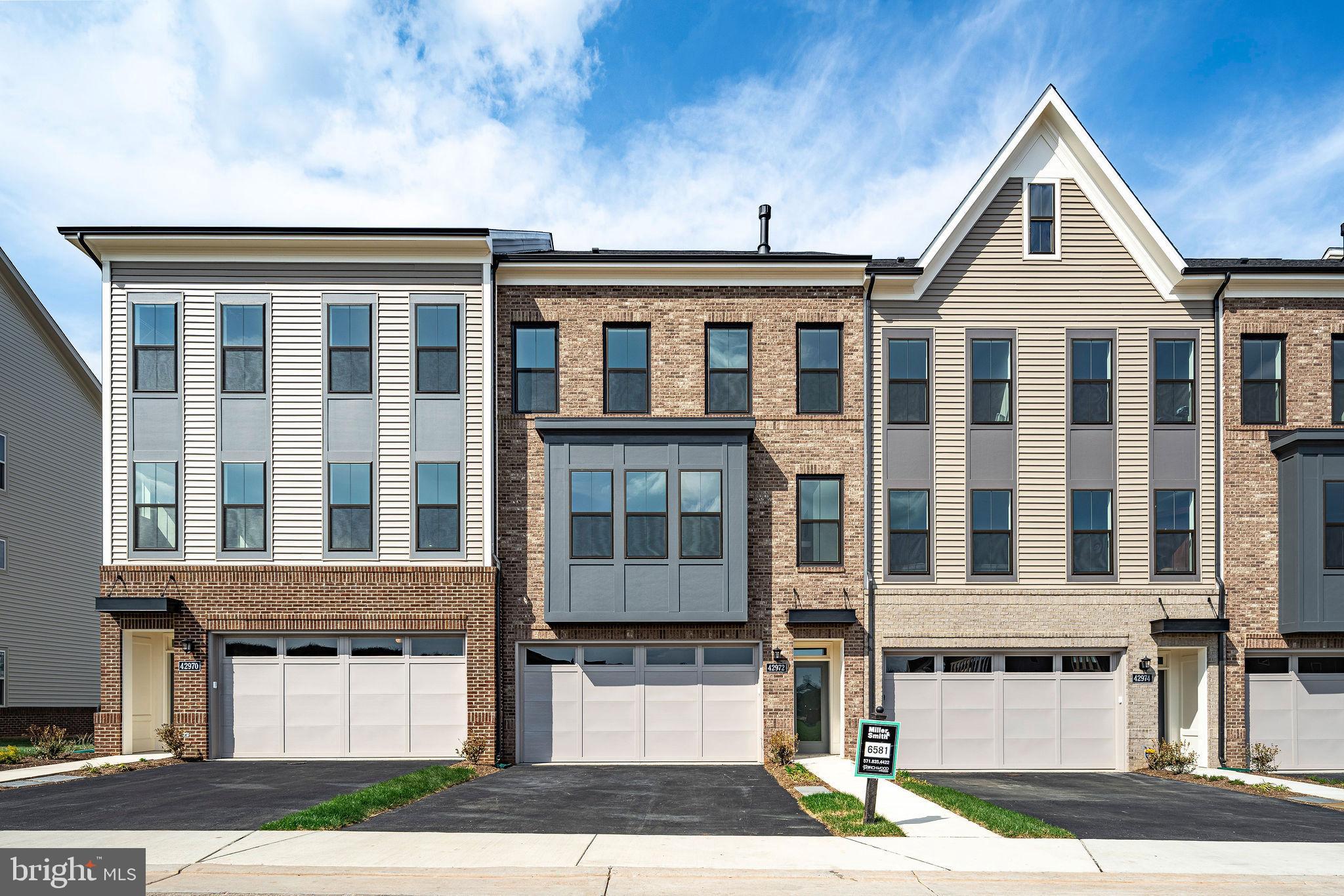 THIS IT IT - NEW MILLER & SMITH QUICK MOVE-IN ELEVATOR TOWNHOME in 55+ BIRCHWOOD COMMUNITY. Discover the Miraval floorplan with 2,742 sq. ft. will WOW! Featuring a private elevator, 3 bedrooms and 3.5 baths. This open-concept home includes a two-car garage, 9-foot ceilings, and high-end finishes throughout such as enhanced vinyl floors, 42" shaker kitchen cabinets, quartz countertops, stainless steel appliances, gas fireplace, screened porch, and concrete patio. Enjoy the lifestyle you've been waiting for at Birchwood at Brambleton, with exclusive clubhouses including indoor and outdoor pools, exercise room, art studio, demonstration kitchen, and so much more! A home to love longer! List base price subject to change.   SALES OFFICE OPEN DAILY FROM 11 am to 6 pm.