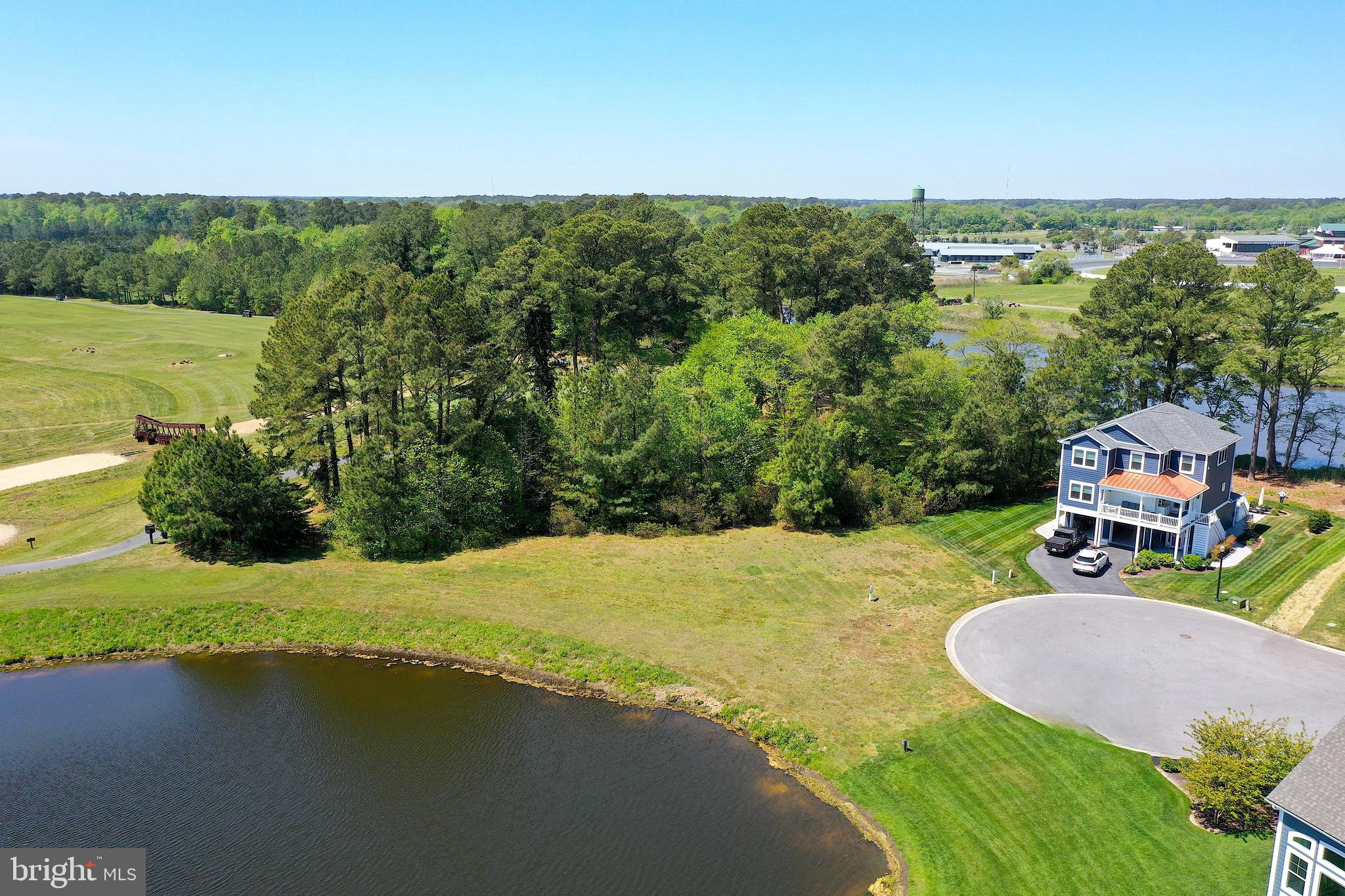 Discover the perfect setting for your dream home on this exceptional 0.88-acre waterfront lot, offering scenic views of Mud Creek paired with the wide-angle golf course views. Nestled within a gated, amenity-rich community, this homesite combines privacy, natural beauty, and resort-style living. Enjoy public water and sewer access, making your build even more convenient. Residents have access to an impressive array of amenities, including tennis and pickleball courts, a clubhouse, fitness center, swimming pools, marina facilities, and optional golf course memberships. Whether you’re drawn to the tranquil water views, the lush fairways, or the vibrant community lifestyle, this property delivers it all in a prime location.