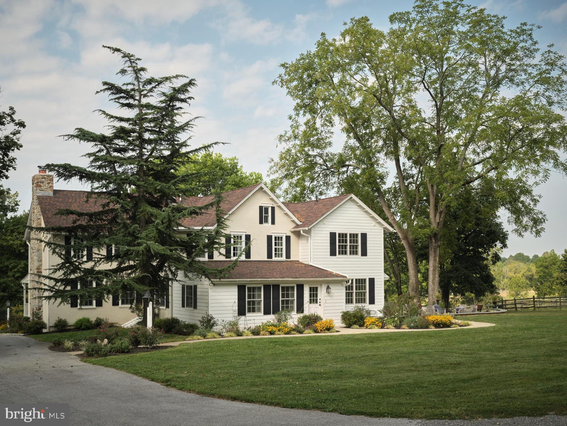 Don’t miss this exceptional opportunity to combine your love of equestrian activities with a totally renovated 1890 Farmhouse on 19.4 pristine acres in Radnor Hunt.  “Windy Hill Farm" is located in the heart of Willistown Township in a peaceful rural setting, yet close to all the conveniences of the local area.  Imagine enjoying colorful sunsets from your large flagstone terrace while watching horses graze in the fenced pastures.  This farmhouse, which was completely renovated in 2018, combines the best features and amenities of new construction with the charm of the late 19th Century.  This home features a large covered front porch, five bedrooms, five en suite bathrooms, hickory wide-plank flooring, two fireplaces, a chef-worthy kitchen with appliances by Wolf, Sub-Zero and Bosch, a spacious and bright breakfast boom, all with open access to the family room. A center hall floor plan with a formal living room and dining room, an ADA-accessible bedroom and full bath, a mud room and powder room complete the first floor.  The second story includes a lovely primary suite featuring an en suite bath with radiant heated flooring, soaking tub, separate vanities, and a large frameless glass stall shower.  Three additional bedrooms, all with en suite baths, a laundry room and walk-up access to the third-floor attic, complete the second level. Enjoy amazing views from every window on each floor. The property includes two parcels, with the larger 12.1 acre parcel being part of the Brandywine Conservancy.  This parcel with its rolling terrain includes a stream, fenced pastures with water stations and generous turn-out.  The remaining parcel of 7.3 acres includes the farmhouse, a 15-stall stable area with a European-style center courtyard, wash stall, feed room, tack room and additional fenced pastures.  A large two-story party barn, with a wood-burning stove, is a great place for the whole family to relax and entertain. The party barn includes a 30-foot garage with an extra-high ceiling that could easily accommodate a car lift.  A chicken coop with a large enclosed run for your chickens and a “She Shed” overlooking the 100 x 200 outdoor riding ring complete the primary parcel.  Being catty-cornered to Applebrook Golf Club makes it a short trip to the first tee!  The property is adjacent to miles of trails for pleasure and trail riding, all while providing quick access to the shops and restaurants of Malvern and West Chester, as well as the rails to Philadelphia and NYC.  Just a 30 minute drive to PHL.  Privacy with convenience make this a perfect location.  Award-winning Great Valley Schools and multiple private schools are an added bonus.  Make this property your Chester County oasis.  Please do not enter the driveway without a confirmed appointment.  Thank you!