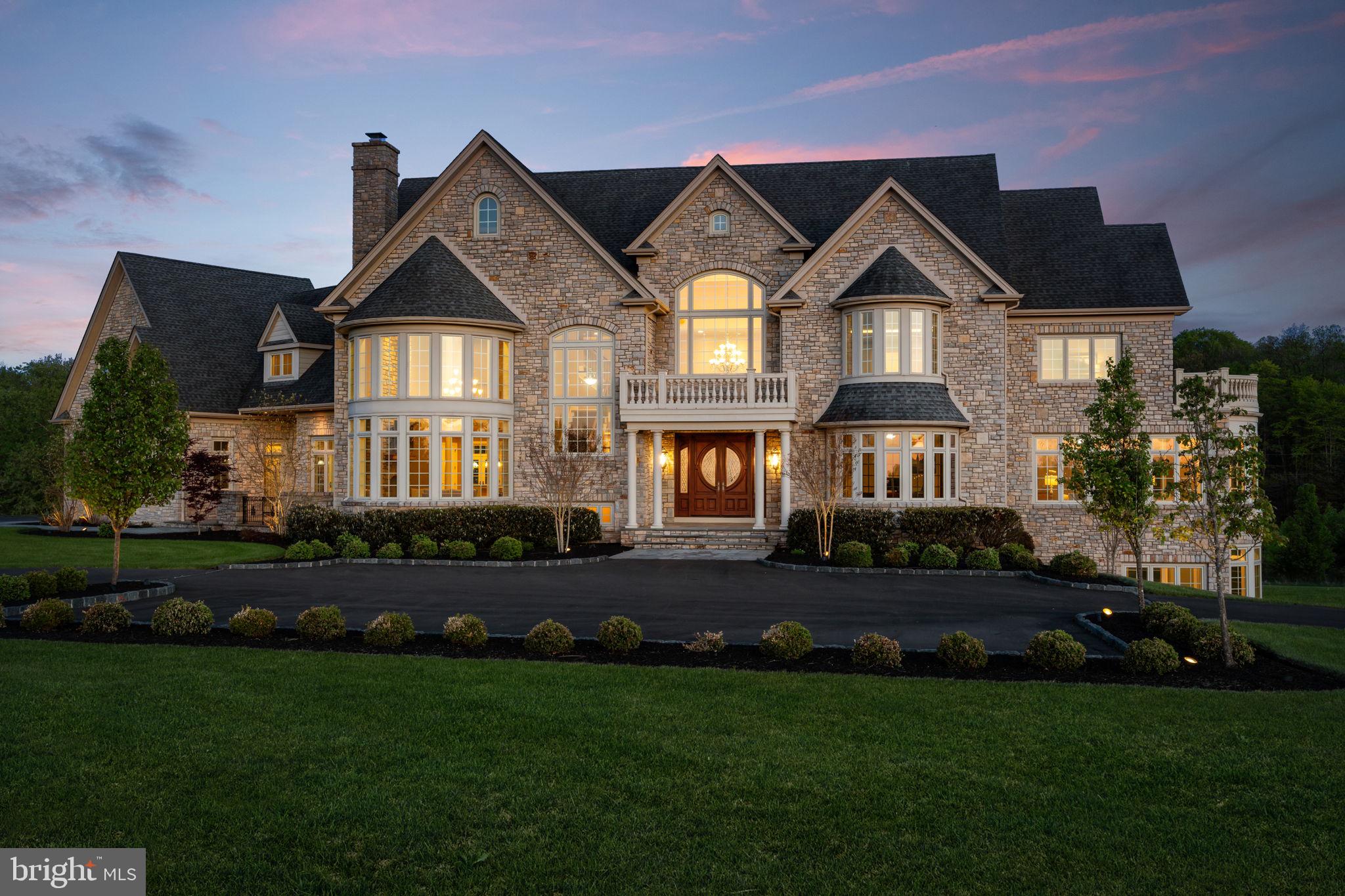 Perched at the pinnacle of an exclusive Upper Makefield Township enclave, this extraordinary residence by Zaveta Custom Homes offers over 10,000 square feet of refined finished living + an additional 3,500+ unfinished space (13,895 TOTAL), set on just about 13 acres of breathtaking, private grounds. Within the expansive acreage, 3 acres are available to build a second home on the property. Tucked away at the top of the neighborhood, the property delivers a rare blend of seclusion, grandeur, and timeless craftsmanship. A striking full-stone exterior sets the tone for what lies within three impeccably designed levels of luxurious living space where elegance meets modern comfort. The residence features five generously appointed bedrooms and six beautifully finished bathrooms, each curated with the finest materials and attention to detail. From the moment you enter, soaring ceilings, expansive windows, and exquisite millwork create an atmosphere of sophistication and light. The main level is designed for both grand entertaining and intimate living, with seamless flow between formal and informal spaces. A chef’s kitchen anchors the home, complemented by premium appliances, custom cabinetry, and thoughtfully designed gathering areas. The upper level offers a serene retreat, highlighted by a lavish primary suite with a spa-inspired bath and tranquil views of the surrounding landscape. Additional bedrooms provide comfort and privacy for family and guests alike. The fully finished lower level expands the home’s versatility, ideal for recreation, wellness, or entertainment, all while maintaining the same elevated standard of design. Outdoors, the 13-acre setting is nothing short of spectacular; rolling lawns, mature trees, and uninterrupted natural beauty create a private sanctuary just moments from the charm of Bucks County. Despite its serene, tucked-away setting, the property offers exceptional accessibility. Enjoy convenient proximity to New Jersey, seamless access to New York City, and easy connections to major highways providing direct routes north and south, as well as a straight shot east to the renowned Jersey Shore beaches. This is more than a home. It’s a statement of luxury, privacy, and enduring quality in one of the region’s most coveted locations. *Virtual Exterior Imagery Used*