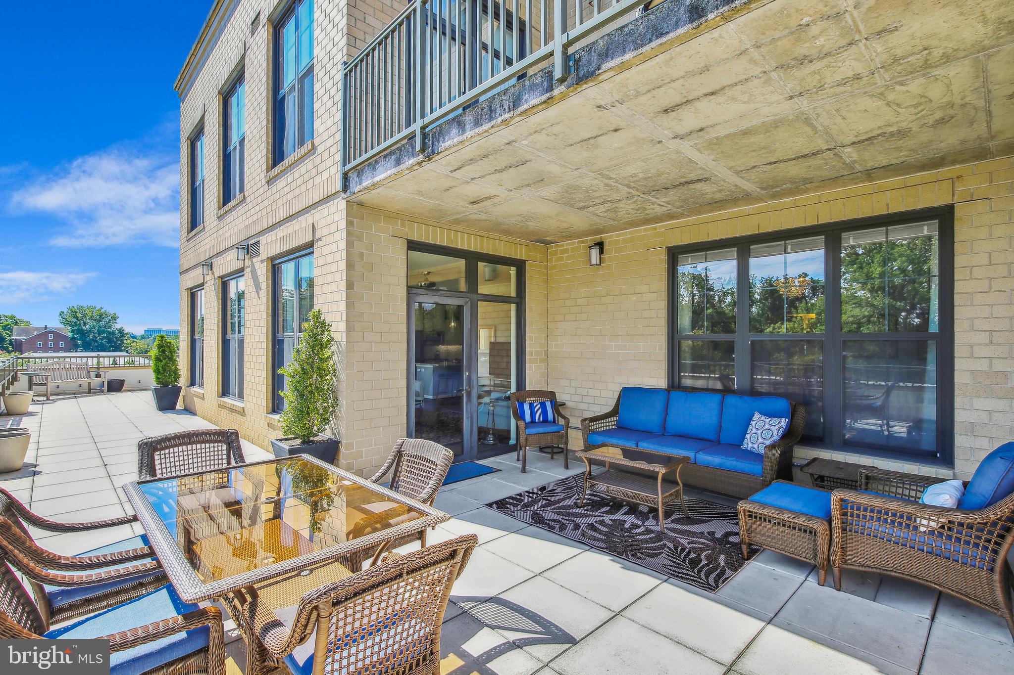 One of a kind opportunity!  Relax on your PRIVATE 60 foot + terrace in the heart of Falls Church City.   This is penthouse living at its finest in Falls Church City and only two of these units were built.   The home is completely turn-key and you will feel like you are on vacation while sitting in the living room and peering through a wall of windows over-looking the private wrap-around (60 feet+) terrace.  The terrace creates an extraordinary amount of additional outdoor living/entertaining space, all overlooking  quiet Park Ave--you have to see it to believe it; especially the spectacular sunsets!  Inside you will find two expansive bedrooms, 2 ½ baths, and a nicely sized den with a barn door that can be used for work or even an additional overnight guest!   The kitchen was beautifully redone and upgraded in 2021 with white and dark wood cabinets, granite countertops, and high-end stainless-steel appliances.  The flooring for the entire unit was also all completely replaced with wide plank hardwood in 2021.  Did we mention this unit includes an unheard of three (3) garage parking spaces! The unit includes a secure storage space just down the hall. The building amenities include: a beautiful lobby with a front desk concierge and package, mail, and newspaper delivery (1st Floor), a building-wide security system, a fitness center (4th Floor), party and media rooms (3rd Floor), Wi-Fi ready business suite, central grassy courtyard (3rd Floor) and a green rooftop terrace--perfect for watching fireworks! Located in central Falls Church City, the Spectrum is a short walk to everything you need.  You will be just steps from restaurants and other conveniences such as Harris Teeter, CVS, FedEx, Starbucks, the Falls Church Farmers Market, Panera Bread, the State Theater, Cherry Hill Park, and the newly-expanded Mary Riley Styles Public Library.  The City of Falls Church has recently upgraded and expanded many of its wonderful outdoor amenities including the expansion of the W&OD trail with a NEW pedestrian walking bridge leading to the East Falls Church Metro Station.  There is also quick access to both East and West Falls Church Metro Stops, Tysons Corner, Arlington, Mclean, DC and all major commuter routes (I66, 495, Dulles toll Road).   Don't miss this one, it won't last!  Condo fee includes: gas, water, sewage, trash,  cable (COX) and internet (200mb).  Hot water is supplied by the building.   Parking Spaces are 195, 196,  &219.  Condo Association maintains terrace, windows, and exterior doors. Elevator fee ($500)  is refundable; move-in fee ($350)  is not.