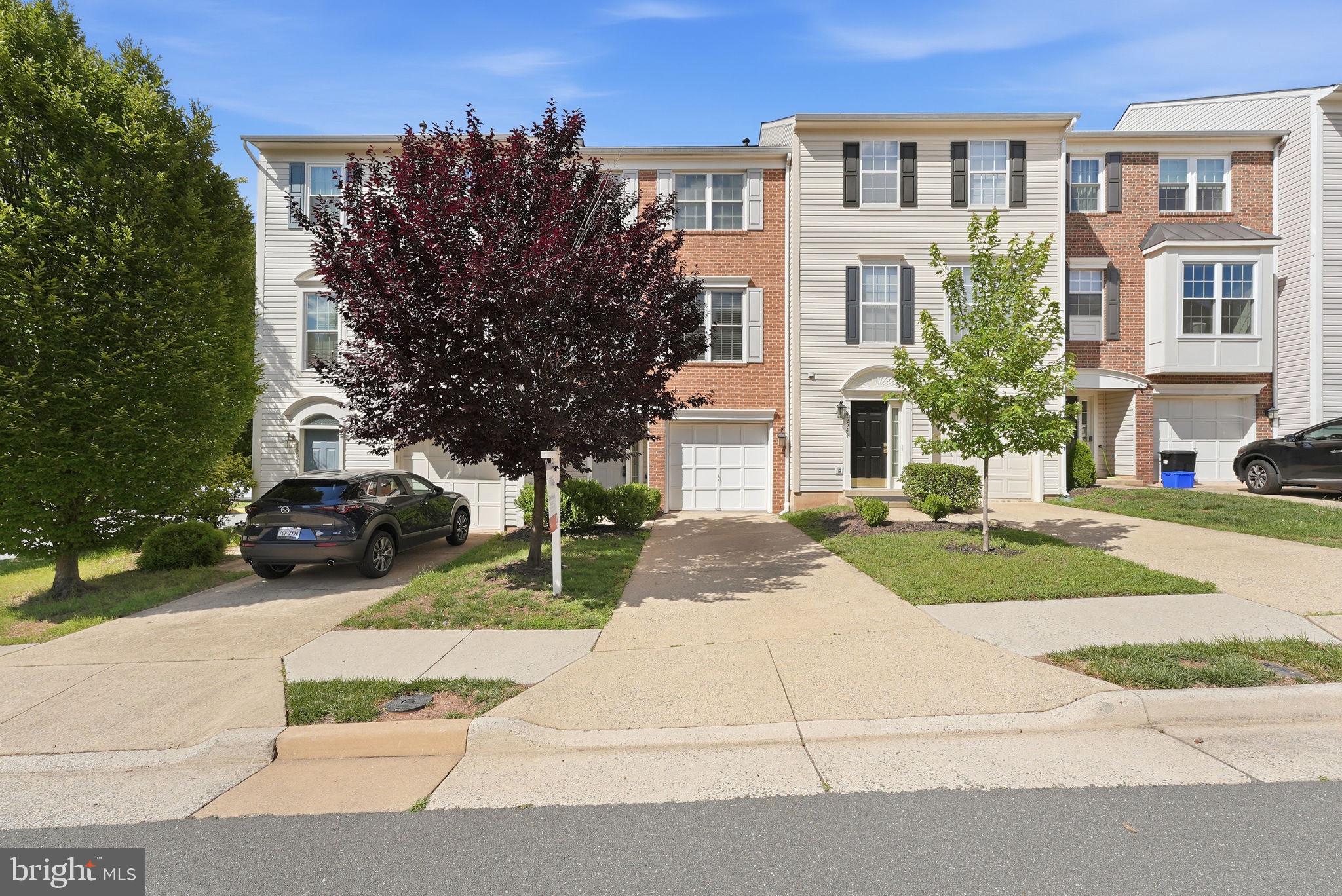 OPEN SATURDAY FROM 11AM-1PM! Welcome to this three-level townhome in the highly desirable Dominion Station community in Sterling Virginia. Step inside to a spacious foyer that creates an inviting first impression. The entry level features a versatile recreation room filled with natural light, a convenient half bath, and direct access to the private backyard, complete with low-maintenance turf—perfect for outdoor relaxation, entertaining, or play. The main living level offers an open and functional floor plan designed for modern living. Hardwood flooring flows throughout the family and dining areas, creating a warm and cohesive space for everyday living and gatherings. The kitchen is thoughtfully appointed with updated appliances, abundant cabinetry, and generous workspace. Just off the family room, enjoy easy access to the deck, providing an ideal setting for morning coffee or outdoor dining. A gas fireplace serves as a beautiful focal point, adding warmth and character to the living area. The upper level features three bedrooms, including a spacious primary suite designed for comfort and retreat. The en-suite bathroom showcases ceramic tile flooring, a soaking tub, separate standing shower, double-sink vanity, and ample space to unwind at the end of the day. Two additional bedrooms and a full hall bathroom complete the upper level. With easy access to Dulles International Airport, Routes 7 and 28, and an abundance of shopping and dining options, this residence offers a lifestyle defined by comfort, connectivity, and convenience. A MUST SEE!