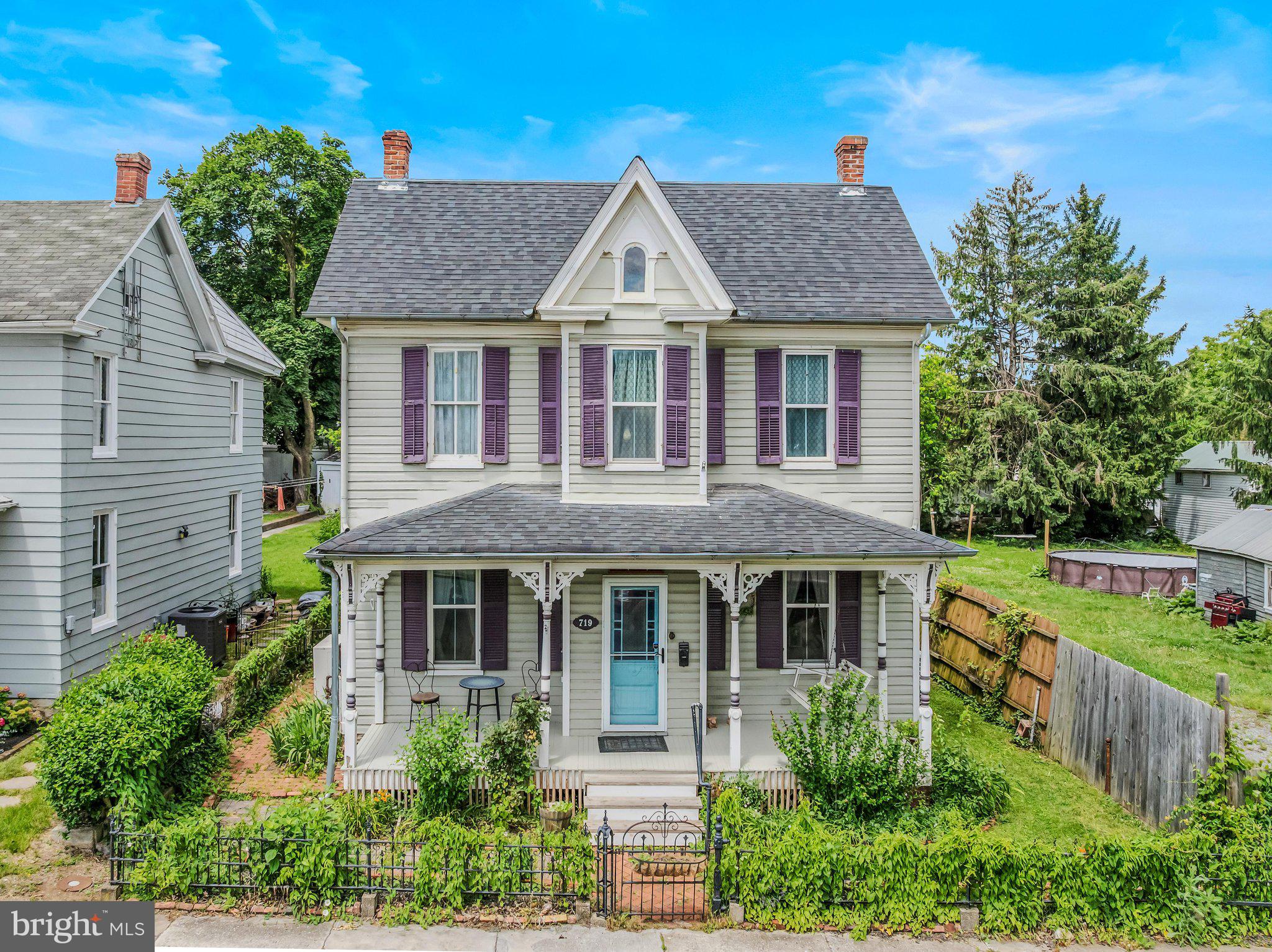 This charming Colonial home, built in 1910, offers a perfect blend of classic character.. Step inside to discover warm wood floors and a traditional floor plan that invites you to relax. The eat-in kitchen is equipped with essential appliances, including a front-loading washer and dryer, making daily tasks a breeze. Enjoy cozy evenings in the living room, enhanced by built-ins and ceiling fans for added comfort. Outside, the property features a welcoming porch, perfect for morning coffee or evening chats. The rear yard provides a private retreat, while the detached garage offers convenient parking and storage. Located in the heart of downtown, you'll appreciate easy access to transportation options, including a commuter rail station and bus stops just a short walk away. With city views and nearby amenities, this home is a delightful sanctuary that balances convenience and tranquility. Experience the warmth and charm that awaits you in this inviting space!