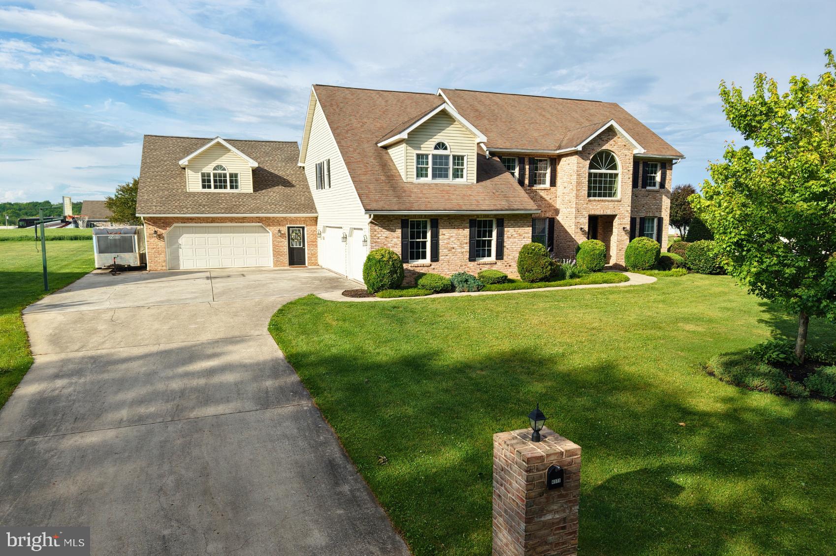 If you’ve been searching for a home with space to spread out, a setup built for entertaining and a location that offers gorgeous views, this one deserves a closer look! Located within the Greencastle-Antrim School District, this home offers over 4,100 finished square feet of living space with 4 bedrooms, 3.5 baths and plenty of upgrades and amenities that are tough to find all at the same property. Originally designed as a 5-bedroom home, one bedroom was converted into a dedicated laundry room for added convenience, but could easily be converted back into a bedroom if desired. Set on a spacious 0.57-acre lot along a quiet cul-de-sac street, the property offers beautiful country views and a more rural feel while still maintaining the convenience of a neighborhood setting, just minutes from town. Inside and outside, the home provides multiple areas for gatherings, entertaining, relaxing and everyday living, including an open floor plan setup on the main level which leads out back to the pool deck. The primary bedroom features a walk-in closet with an additional separate hall closet, along with its own primary bathroom featuring a separate tub and tile shower, and a double sink vanity for convenience. The finished lower level adds even more usable space with a pool table area, surround sound hookups, kitchenette, and additional storage—creating an ideal setup for hosting guests or creating a private hangout space. Step outside and you’ll quickly see what makes this property stand out! The fenced backyard surrounds the stamped concrete pool deck for the in-ground saltwater pool and hot tub. And there’s even a fire ring area beyond the fence that creates the perfect setting for relaxing and taking in those beautiful countryside views. Additional standout features include geothermal heating and cooling for long-term efficiency, as well as 2 separate attached garages, one with vaulted ceilings equipped with a vehicle lift and air compressor—an impressive setup for car enthusiasts, hobbies, projects or workshop space. If you’ve been waiting for a property that combines indoor living space, outdoor entertaining, and a setting that offers both privacy and convenience, this is one you’ll want to experience in person!