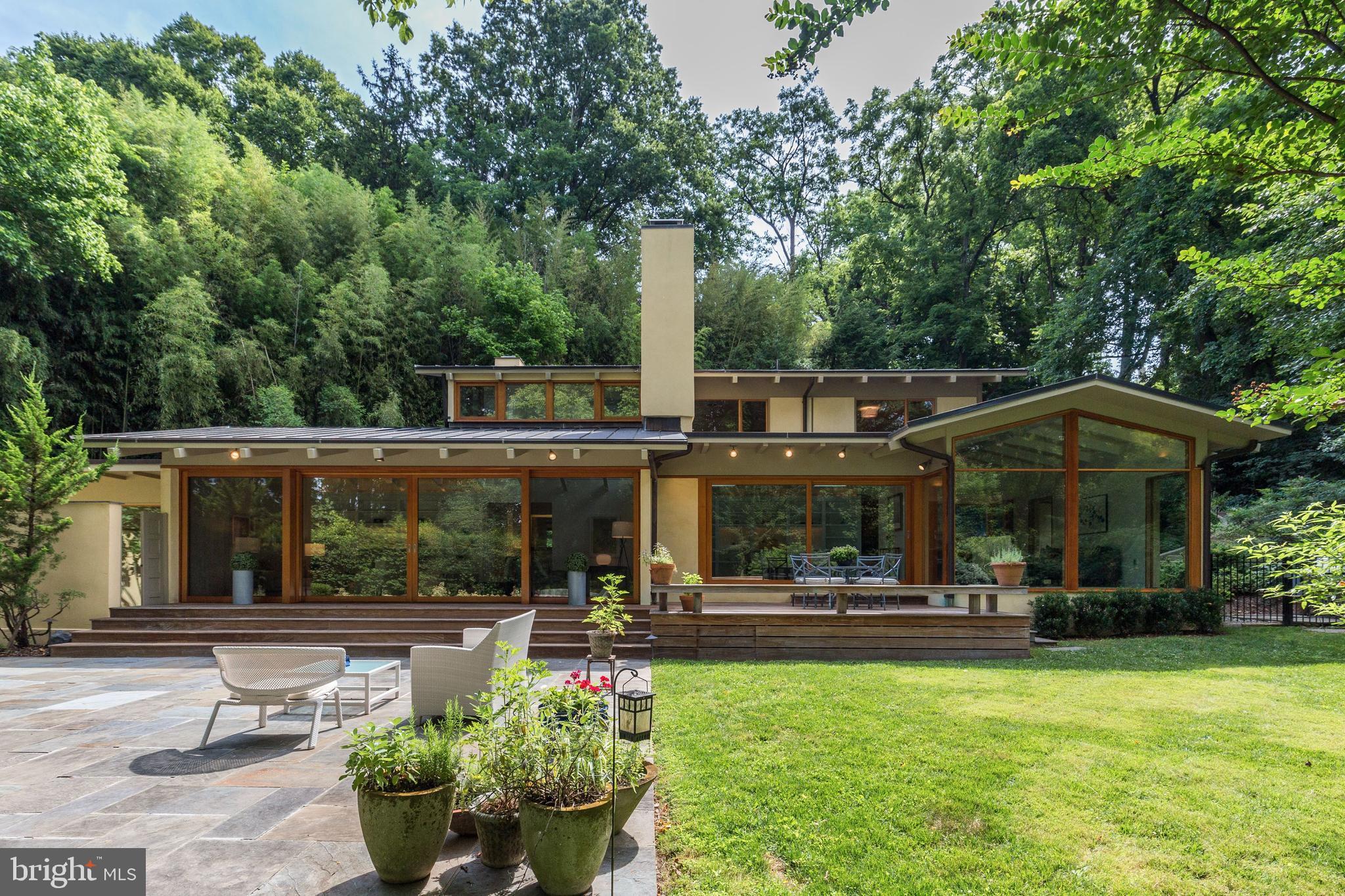 Rare mid century jewel completely hidden from street, nestled in woods in heart of the city. Renovation by Mark McInturff. Behind discreet facade is stunning glass entry overlooking beautiful pool/garden. Lg rms, high ceilings & dramatic walls of glass create exceptional indoor/outdoor interface + superb flow for entertaining. Kitchen opens to FR. Owner/Agent