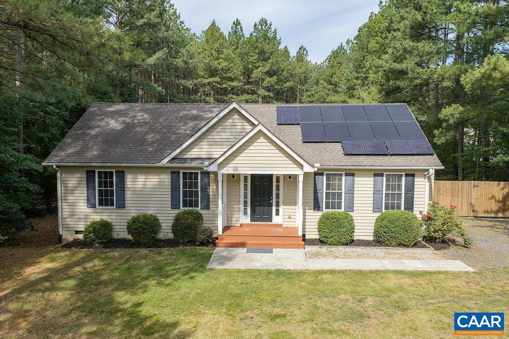 This single level, lovingly maintained rancher is nestled in a quiet spot just outside of the town of Scottsville. Features include a light and bright open plan, vaulted ceilings, gleaming hardwood floors, and generously sized bedrooms. Just off the dining area is access to the back deck, which is large enough for dining, grilling, and entertaining. The deck overlooks the large, level lot (3 acres!), which is perfect for pets, play, and gardening. Toward the rear of the yard is a garage with electricity and which could also serve as an ideal workshop. Near the garage is an RV parking pad, complete with electric and a water bib. Additional shed for storage. The solar panels are a great benefit, reducing utility costs! Just 10 min to restaurants and shopping in Scottsville and 30 minutes to all things Charlottesville.,Fireplace in Living Room