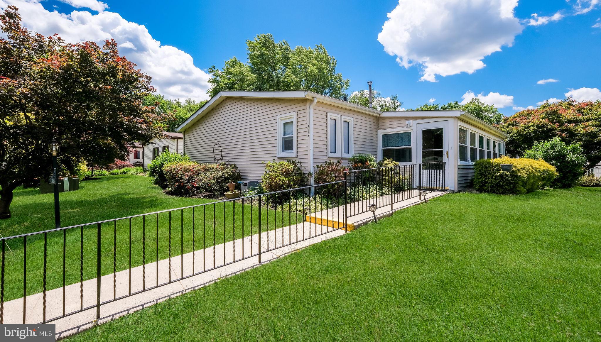 Fabulous 3 bed, 2 bath home offering 1,680 sqft of interior living space; one of the largest models available!  Features an enclosed front porch and a spacious rear patio with an electric awning, providing comfortable outdoor space for relaxing and entertaining.  Bright, open floor plan seamlessly connects the living room dining area and den.   Remodeled bathrooms and a wood pellet stove in the living room for added warmth and charm!  Excellent location with convenient one-step entry into the home. The Village of Neshaminy Falls is a 55+ Active Adult Community with a gorgeous newly rebuilt clubhouse featuring a library,  fitness room and game room. From the clubhouse walk out to the wrap around Veranda that overlooks the heated inground pool.  Many activities/clubs for your enjoyment including weekly shuttle bus to markets and so much more to offer. The monthly ground rent covers the community room, shuttle, sewer, trash, common area maintenance and snow remove of streets. If looking for a  large 3 bedroom home, definitely put this one on your list--just needs your finishes touches!