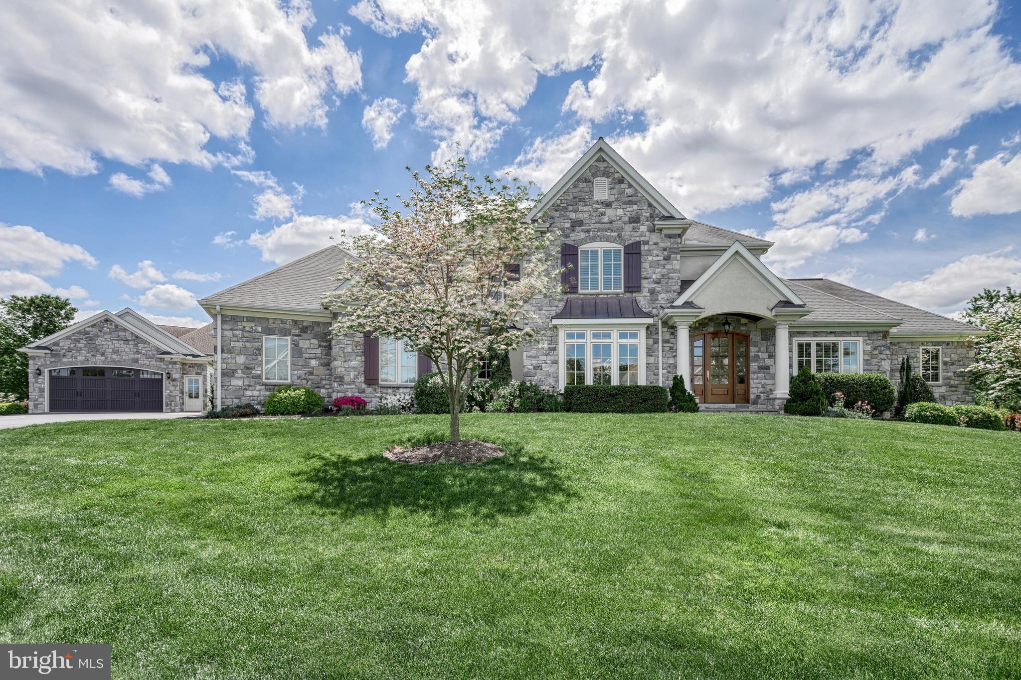 OPEN HOUSE CANCELED - Sorry for any inconvenience. Discover Braeburn Estates, an exceptional custom community in the heart of Central Pennsylvania. Convenient to Rt. 15 and PA Turnpike, this premier neighborhood is an integral part of the esteemed Smart Growth community of Winding Hills. Residents enjoy over 365 acres of preserved open space, complete with walking trails, woodlands, and integrated parks. The community's design features charming cobble roundabouts, sidewalks, and streetlights, all leading to a central social hub with a grand clubhouse, gym, and saltwater pool. Every detail of this custom home was considered with the utmost care for scale, function, and beauty. The timeless character and unsurpassed quality is evident. From the curving slate walkway to the striking portico with elegant pillars, you will notice you are about to enter a home that exemplifies distinction. Soaring two story foyer, turned volute staircase, and wrought-iron spindles lead you to an impressive great room boasting 12-foot ceilings, custom-built bookshelves, a distinguished fireplace with a Samsung Frame TV, and a striking wall of windows that fills the space with natural light. The main level showcases elegant architectural details; including lighted tray ceilings, crown molding, shadowbox, custom profile trim, and beautifully cased arched openings. The gourmet eat-in kitchen serves as the heart of the home, featuring luxurious leathered granite countertops, top-of-the-line Thermador appliances, a custom stone backsplash, a custom hood, a warming drawer, a hidden walk-in pantry, a large center island with prep sink and overhang. Just off the kitchen is the formal dining room with plush window seat. The den sits quietly off the foyer behind French doors. The first-floor owner’s suite provides a tranquil retreat. The sitting area has direct access to the rear deck. An opulent spa-like five-piece bath. Palatial separated vanities span two walls. The tile walk-in shower features a viscy rain shower and tile bench, and the relaxing corner jetted tub is framed by windows with gorgeous plantation shutters. Two enormous walk-in closets. Upstairs, there is a generous landing that connects three additional spacious bedrooms. An ensuite and a hall bath with double bowl vanity and linen closet. The owner entry offers built-in storage nooks, roll out filing drawers, shelves, and a seat with storage underneath. Off the entry is a large laundry room with built-in folding table and base cabinets, drying rack for hanging clothes, and a built-in wash basin with base cabinets. The powder room has a granite top and Kohler cast iron undermount sink. The exposed walk-out lower level is an entertainer's dream, complete with a custom bar area, an impressive wine cellar, a spacious rec room with a built-in media center, a private gym, a full bath, and abundant natural light. The beautiful setting for this gorgeous home offers a perfect blend of indoor and outdoor living. Enjoy a beautifully landscaped corner homesite, an expansive composite deck, and a lower-level patio, providing endless possibilities for outdoor entertainment. The screened porch offers a perfect spot for reading or unwinding. Additional highlights of this remarkable home include energy-efficient gas heat, three zones of heating and cooling, gas hot water, water softener, radon mitigation system, 400 amp electric service, generator, and a superior wall foundation ensuring lasting durability and comfort. Car enthusiasts will delight in this rare five-bay garage. Three cars side entry, two cars detached. Located within Upper Allen Township and served by the highly-regarded Mechanicsburg Schools, this home offers a perfect fusion of luxury, comfort, and thoughtful design. I encourage you to schedule your private showing today to truly experience all that this exceptional property has to offer.
