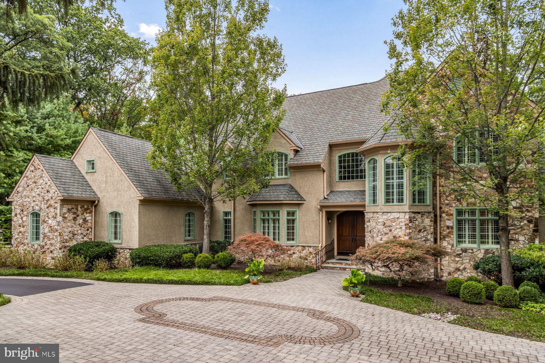 A remarkable blend of timeless architecture, thoughtful craftsmanship and exceptional flow of indoor-outdoor living. This custom-built estate is tucked away on 1.3 beautifully manicured acres in the sought-after Valley Forge Mountain community. Designed to embrace both grand-scale entertaining and comfortable everyday living, every space has been carefully curated with an emphasis on quality, functionality and connection to the surrounding natural landscape. A dramatic two-story foyer introduces the home's impressive scale, while rich architectural details, custom millwork and expansive windows create an atmosphere that is both elegant and welcoming. The spectacular great room serves as the heart of the home, featuring soaring ceilings, custom built-ins, a gas fireplace and wet bar. The gourmet kitchen is designed for both serious cooks and casual gatherings, complete with an oversized center island, granite countertops, premium stainless-steel appliances including a Thermador five-burner cooktop, double dishwashers, separate refrigerator and freezer. A butler's pantry with wine refrigeration, coffee station and exceptional storage provides seamless support for entertaining. An inviting breakfast area opens via a Nano wall into the screened-in porch sitting area complete with handsome stone fireplace and serene views. The screened porch provides access to an expansive deck with staircase to ground level pool area. Outside, the property transforms into a private resort. The heated saltwater pool is surrounded by extensive hardscaping, multiple patios, a floating deck with canopy, fire pit, mature landscaping and numerous gathering spaces that invite everything from intimate evenings to memorable celebrations. The first-floor primary suite is a luxurious private retreat featuring its own fireplace, access to a secluded deck, an expansive custom walk-in closet with center island and a spa-inspired bath with soaking tub, dual vanities and an oversized river rock shower with rain head. Additional living spaces on the main level include a private home office, formal dining room, spacious laundry room, powder room for guests and direct access to the attached three-car garage. Upstairs, generously sized bedrooms provide comfortable accommodations, including a private guest suite, a jack-and-jill wing, a flexible den with powder room and fitness room that can easily serve as an additional bedroom or studio. The walk-out lower level offers a kitchenette, second laundry room, massage room, powder room, separate shower, abundant storage and direct access to an outdoor entertaining area complete with a covered bar and vintage schoolhouse sink.  Valley Forge Mountain is known for its extensive trail network offering miles of hiking and direct connections to regional cycling routes that ultimately link to the Schuylkill River Trail. Residents also have the opportunity to join the Valley Forge Mountain Association, which offers a community pool, tennis courts, playground and a calendar of neighborhood social events. Just a short walk away is the internationally acclaimed Wharton Esherick Museum, the former home and studio of legendary American artist and furniture designer Wharton Esherick. Nestled within the surrounding woodlands, the museum offers a unique cultural experience featuring extraordinary handcrafted furniture, sculpture and architecture that draws visitors from around the world. Perfectly positioned near Phoenixville, Malvern, Paoli, Wayne, King of Prussia and the Main Line. Convenient access to major highways, regional rail, premier country clubs, renowned private schools, exceptional dining, boutique shopping and commuting routes to Philadelphia, NYC & Wilmington. Offering an extraordinary combination of architectural distinction, resort-inspired amenities, natural beauty and an unparalleled location, this exceptional residence presents a rare opportunity to experience luxury living at its finest.