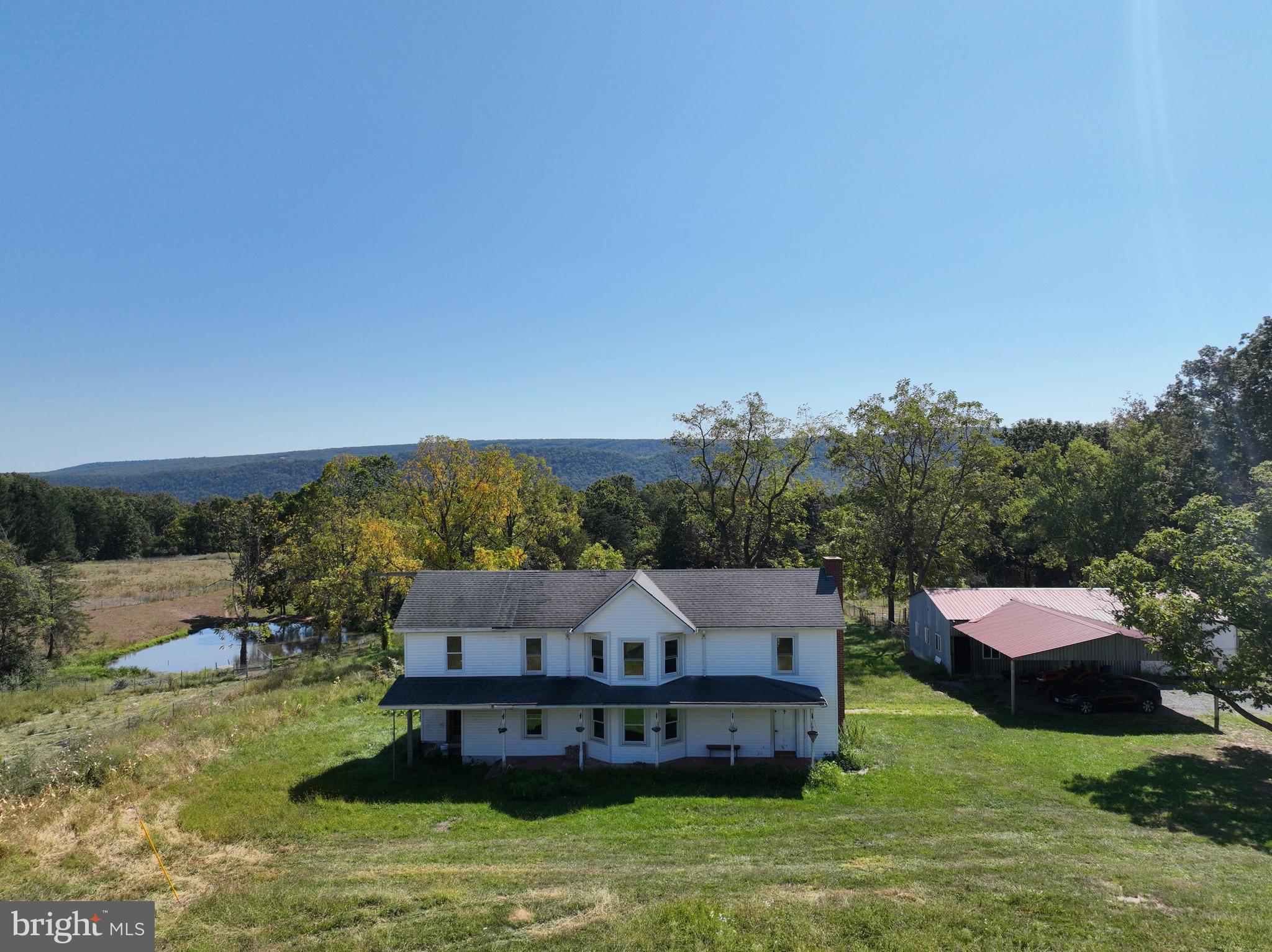 61.5 fully fenced acres with direct North River frontage, set up for livestock, homesteading, or a private retreat. The property has perimeter fencing, multiple paddocks, two wells, and two spring‑fed ponds (one is stocked) that have been used for
vegetable farming. It is also adjacent to an organic vegetable farm, reinforcing the area’s agricultural character and potential.
The 1902 farmhouse is not currently occupied but has the essentials in place: running water, septic, power, and wood heat. It is best viewed as a livable home that would benefit from updating and finish work; some interior finishes and floors need attention, there is no central HVAC, and the roof and siding are older.
This is a land‑first opportunity: fenced pasture and open ground with some woods, established paddocks, spring‑fed ponds, and river frontage for recreation and water access. It suits cattle, horses, sheep, or other livestock, as well as gardens, orchards, or a future custom home site, with strong potential for continued or expanded organic production.
Property is sold strictly as is, ideal for buyers who value acreage, water resources, river frontage, and existing farm infrastructure more than a fully updated house.