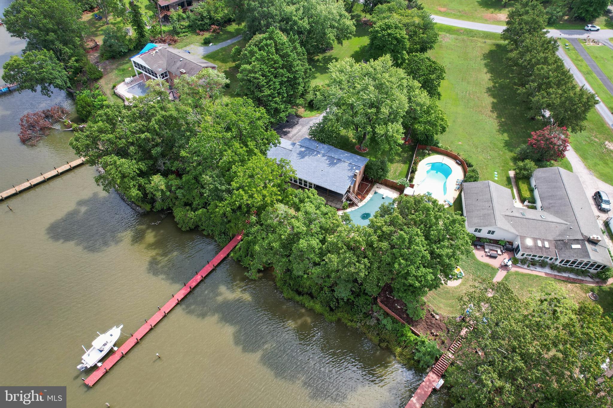 Experience the best of waterfront living in this beautifully maintained split-foyer home situated on 1.15 private acres in a desirable waterfront community. Offering 4 bedrooms and 3 full baths, this property is the perfect blend of comfort, recreation, and relaxation. Currently enjoyed as a second home, it also offers excellent potential as a vacation retreat or short-term rental opportunity (buyer to verify local regulations).

The bright, inviting main level is filled with natural light, while the finished lower level features a cozy propane fireplace, creating the perfect gathering space for family and friends. Additional highlights include a dedicated laundry room, water filtration system, abundant storage, an oversized two-car garage with attic storage, and an additional attic in the home.

Step outside to your own private waterfront oasis featuring an in-ground gunite pool with a Loop-Loc safety cover, 184 feet of shoreline on scenic Battle Creek, and a private pier with boat lift. With approximately 4 feet of water at mean low tide, you'll enjoy easy boating access from your backyard. Battle Creek flows directly into the Patuxent River and onward to the Chesapeake Bay, providing endless opportunities for cruising, fishing, kayaking, paddleboarding, and waterfront adventures. Battle Creek is also one of the few waterways in the area that allows a wake zone, making it ideal for water skiing, tubing, and other water sports. Waterfront restaurants are just a short boat ride away, making every day feel like a vacation.

The community's new pier, currently being completed in 2026 with new pilings, stringers, and decking, provides another wonderful amenity for residents to enjoy.

A new roof installed in 2024 offers added peace of mind. Conveniently located just minutes from Solomons Island, you'll have easy access to charming waterfront restaurants, boutique shopping, marinas, seasonal events, museums, concerts, and the Annmarie Sculpture Garden & Arts Center. Whether you're looking for a year-round residence, a weekend escape, or an investment property with exceptional waterfront appeal, this home offers the lifestyle you've been dreaming of in one of Southern Maryland's premier boating communities.