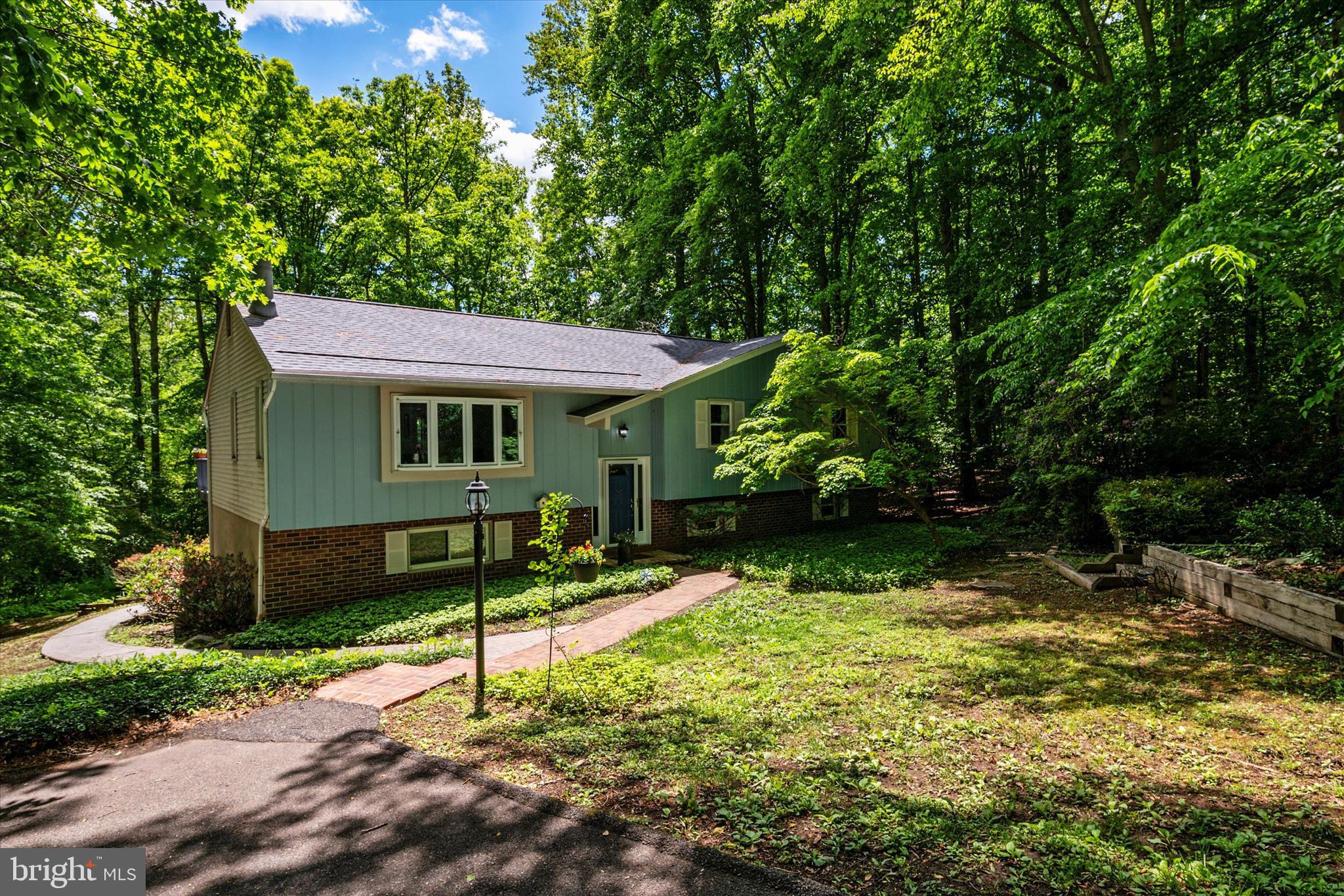 Welcome to Hallmark Woods! Located on a quiet cul-de-sac, this split-foyer home enjoys a tranquil, wooded setting and offers a flexible layout designed for everyday living and functionality.

The main level features a spacious living room with a bay window and freshly painted wood-burning fireplace with brick surround, along with updated LVP flooring (2025). The kitchen includes new quartz countertops and flooring (2026), stainless steel appliances, ample cabinetry, and views of the backyard and deck. Sliding glass doors from the dining area lead out to the deck, which overlooks peaceful wooded views.

The main level includes a primary suite with dual closets and a renovated en-suite bath (2025), plus two additional bedrooms and a full hall bath. The finished lower level offers a large recreation room with walk-out access to the backyard, as well as a full bath and an additional flexible room ideal for guests, a home office, hobby space, or gym.

Additional updates include the roof (2021), new carpet in upstairs bedrooms (2026), fresh paint, and select appliances replaced in 2026.

Outdoor highlights include custom paver walkways, patio and deck areas, wooded views, and a long driveway that enhances the home’s private setting. Conveniently located minutes from shopping and dining in Annapolis with easy access to commuter routes. Don’t miss it!