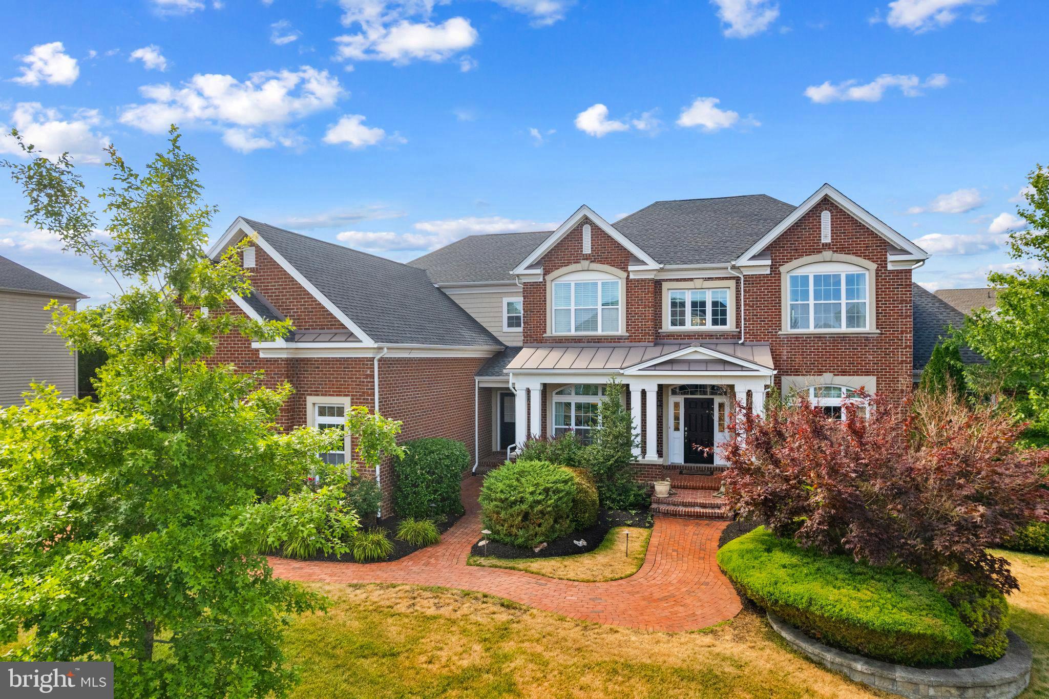 Dear future homeowners of 472 Barrington St an immaculate luxury brick estate home, and, the LARGEST of the homes located in the premier community of Horsham Valley Estates. Let me share some highlights of your new home which is just ten years young and was the original sample house, so you know it comes loaded! It is nestled in a picturesque setting with established professional landscaping. An intricate design of brick pavers lead to your two separate entrances at the front of your home. Additionally, the fully fenced backyard is your relaxation oasis featuring an expansive two-tiered patio designed with EP Henry pavers, a built in stainless steel gas BBQ with granite surface space and storage, a new hot tub and young evergreens for added privacy. Throughout the main floor you have diagonal hardwood flooring, travertine tiles, wainscotting, tray ceilings with double moldings in both the living and dining rooms, a custom beadboard ceiling in the conservatory room just off the living room, and a custom coffered ceiling in the family room. Also throughout your home are custom window treatments, ceiling light fixtures and plenty of recessed lighting on all floors including the three car garage! The attention to detail is even evident in the grand foyer chandelier which rises up and down with the touch of a button for easy cleaning or bulb replacement.  All of the naturally sunlit rooms flow seamlessly on the main floor and there are surround sound speakers in multiple rooms (also the outside patio) making it the perfect home for entertaining, yet, the spaces remain cozy and inviting for family gatherings and making memories.
The family room opens to the gourmet kitchen and features top of the line Jenn Air appliances, ample cabinetry storage including storage on both sides of the massive kitchen island and, a nice sized pantry. Nearby to the kitchen is the laundry room, a mudroom with its own outside entrance, and a back staircase to the second floor. Also close-by is the door that leads into the garage which has an EV charger for electric vehicles, a custom Closet Works storage system, a ProCom gas wall heater and interlocking floor tiles.
On the second floor your generously sized primary ensuite with a sitting room, features a double walk-in shower with bench, separate his and her vanities and his and hers personal commodes. Additionally there are custom fittings in your his and hers walk-in closets. Three remaining good-sized bedrooms complete this floor, one with its own full bath the other two share a full Jack and Jill bath.
The walk-out lower level features a kitchenette with wine cooler and sink, plenty of cabinetry and granite counter space, theater seating with an upgraded movie screen and new speakers, a play area and a half bath large enough to make into a full bath. You also have two unfinished sections that house three HVAC zones and can easily be finished to become another bedroom/in-law suite, a gym, or craft room, perhaps all three and you should still have plenty of extra storage remaining! Added benefits for living on 472 Barrington St is the convenience having direct connection to walk/jog trails, being within walking distance to Simmons elementary, one of the superior Hatboro-Horsham schools, parks and libraries. You will be minutes away from Routes 611 & 309, a short distance to the PA Turnpike, multiple hospitals, food shopping including, Whole Foods, Trader Joes and Giant, numerous restaurants and a wide selection of cultural events. For added peace of mind there is a house alarm system as well as a whole house Generac generator, an indoor sprinkler system in the basement and, a pre-home inspection was preformed. Every home tells a story; now is your chance to start a new chapter in your lives and write your own story, beginning at 472 Barrington St!