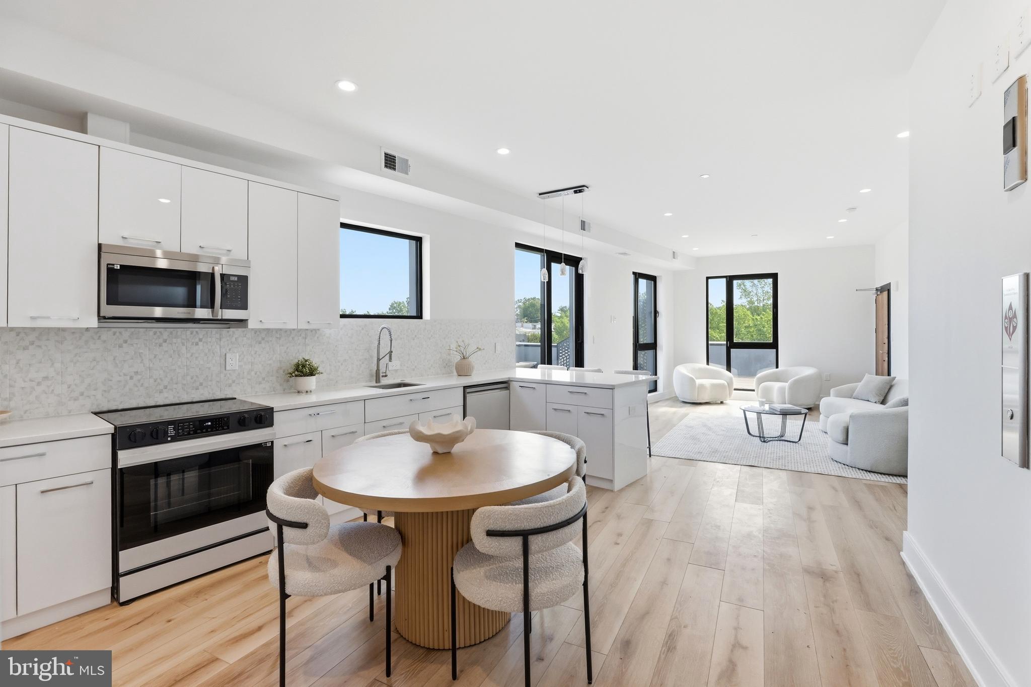 Perched atop 4328 Georgia Avenue NW, this penthouse residence offers approximately 1,300 square feet of light-filled interior space paired with an extraordinary outdoor terrace in the heart of Petworth. Arrive home via private elevator access that opens directly into the residence, where the kitchen immediately welcomes you into an airy open layout designed for both relaxed living and entertaining. Expansive windows draw sunlight throughout the home, creating a bright atmosphere that carries from the main living spaces into the bedrooms.

Positioned along the opposite side of the residence, the two well-proportioned bedrooms offer privacy, abundant natural light, and a comfortable separation from the main entertaining areas. Extending around the home is an exceptional wraparound terrace unlike anything else currently on the market — offering an expansive setting for outdoor gatherings, celebrations, lounging, or enjoying sweeping neighborhood views with an impressive amount of usable space rarely found in city condo living.

Located within a newly constructed elevator building along the Georgia Avenue corridor, residents enjoy close proximity to neighborhood favorites including Hook Hall, Midlands Beer Garden, Call Your Mother, Sonny’s Pizza, Safeway, Yes! Organic Market, local coffee shops, parks, fitness studios, and Metro access — all within one of Northwest DC’s fastest-growing residential communities.