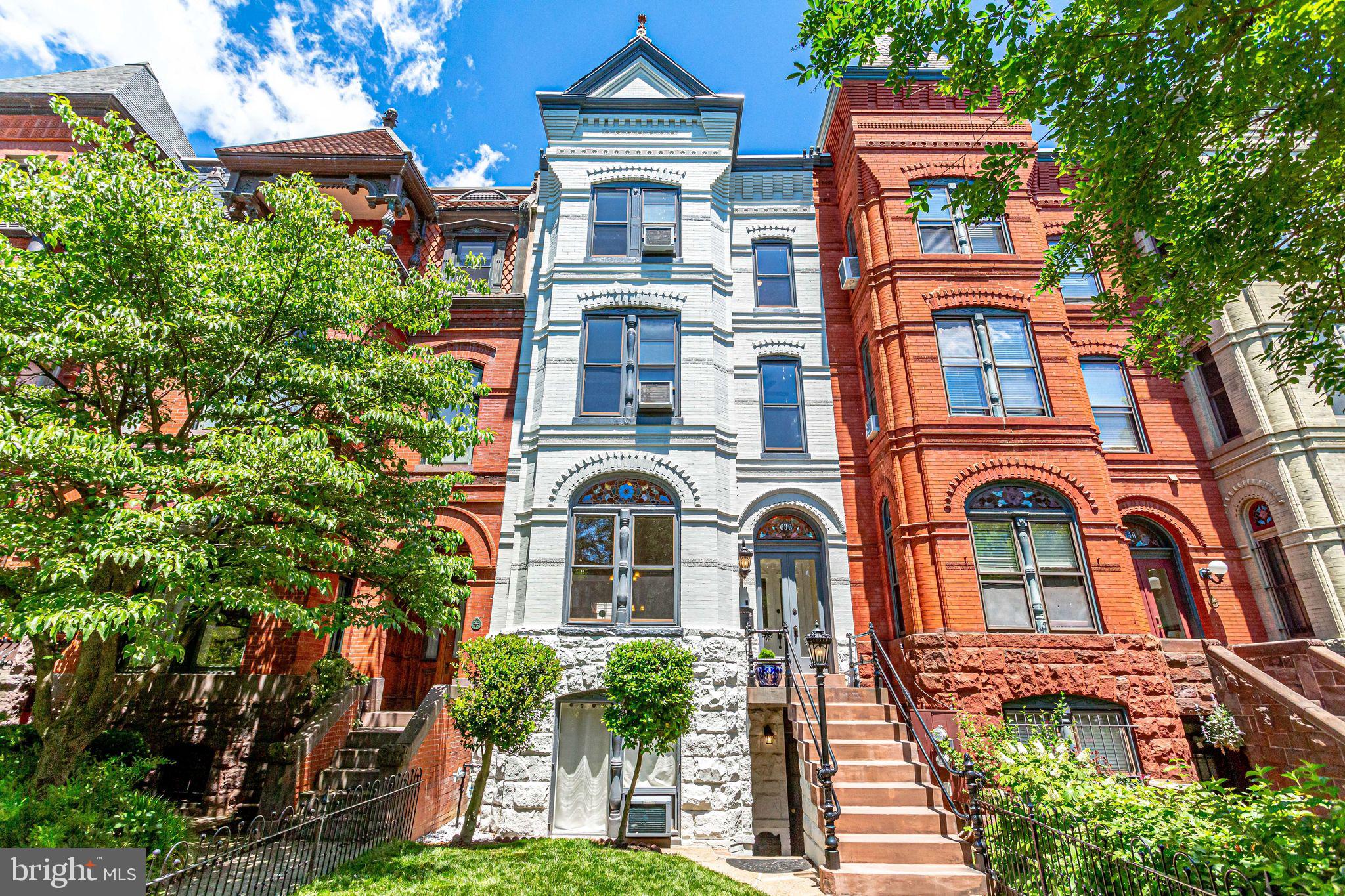 From the Nation's Capitol, East Capitol Street runs due east to the DC-Maryland border.  Some of the choicest real estate can be found on these blocks, and on rare occasions, a very special property becomes available.  Just six blocks from the Capitol, 638 E Capitol St NE occupies a prominent setting in a premier Capitol Hill location.  Facing South, the dwelling enjoys natural sunlight through large windows and top floor skylights.  This unique property is one of three towering Victorians often pictured on publications about Washington DC and Capitol Hill architecture.  DC tax records date the property's beginning to 1908, but it is well documented to have been built by Charles Gessford, who died in 1894.  Between 1875 and 1894, Gessford, one of the city's prolific builders, built more row houses on the Hill than anyone else.  The Capitol Hill Restoration Society counts Gessford-designed properties on 824-832 D St SE and 638-642 East Capitol St SE and NE.  Gessford's row houses usually had a square-cornered projecting bay that stretched from ground to sky, always in red pressed brick, and often with stone trim.  Gessford further enhanced his most expensive houses with stained glass windows and door transoms and slate roofs.  638 E Capitol St NE retains much of its original details including stained glass accents, exposed brick and woodwork.  Throughout, there are modern finishes and architectural touches including coffered ceilings, recessed lighting, gourmet kitchen, marble flooring and multiple fireplaces.  This property also features a finished English basement apartment with its own front and rear doors and a rear brick patio leading to a two story over-sized carriage house.  McLean Stained Glass Studios recently restored four of the lovely stained glass panels to their original glory. This much loved home is now ready for new owners to create their own life spaces!