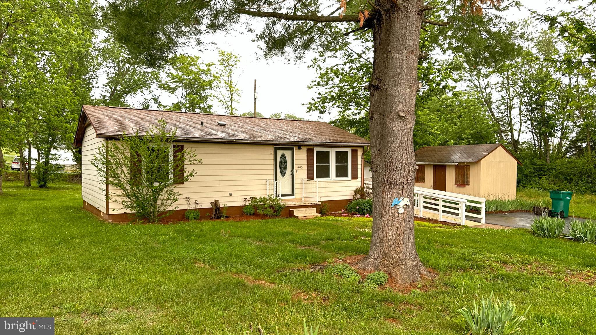 Charming single-level ranch offering comfort, convenience, and easy living all wrapped into one delightful package! This well-maintained home features two bedrooms, a spacious living/ kitchen/dining area  great room perfect for relaxing or entertaining. The full bath includes a convenient roll-in shower for added accessibility. Tucked away at the end of the road, this property offers a peaceful setting while still being close to shopping, schools, and the recreation park. Whether you are searching for the perfect first home, a comfortable retirement retreat, or investment property,  this inviting property checks all the boxes.