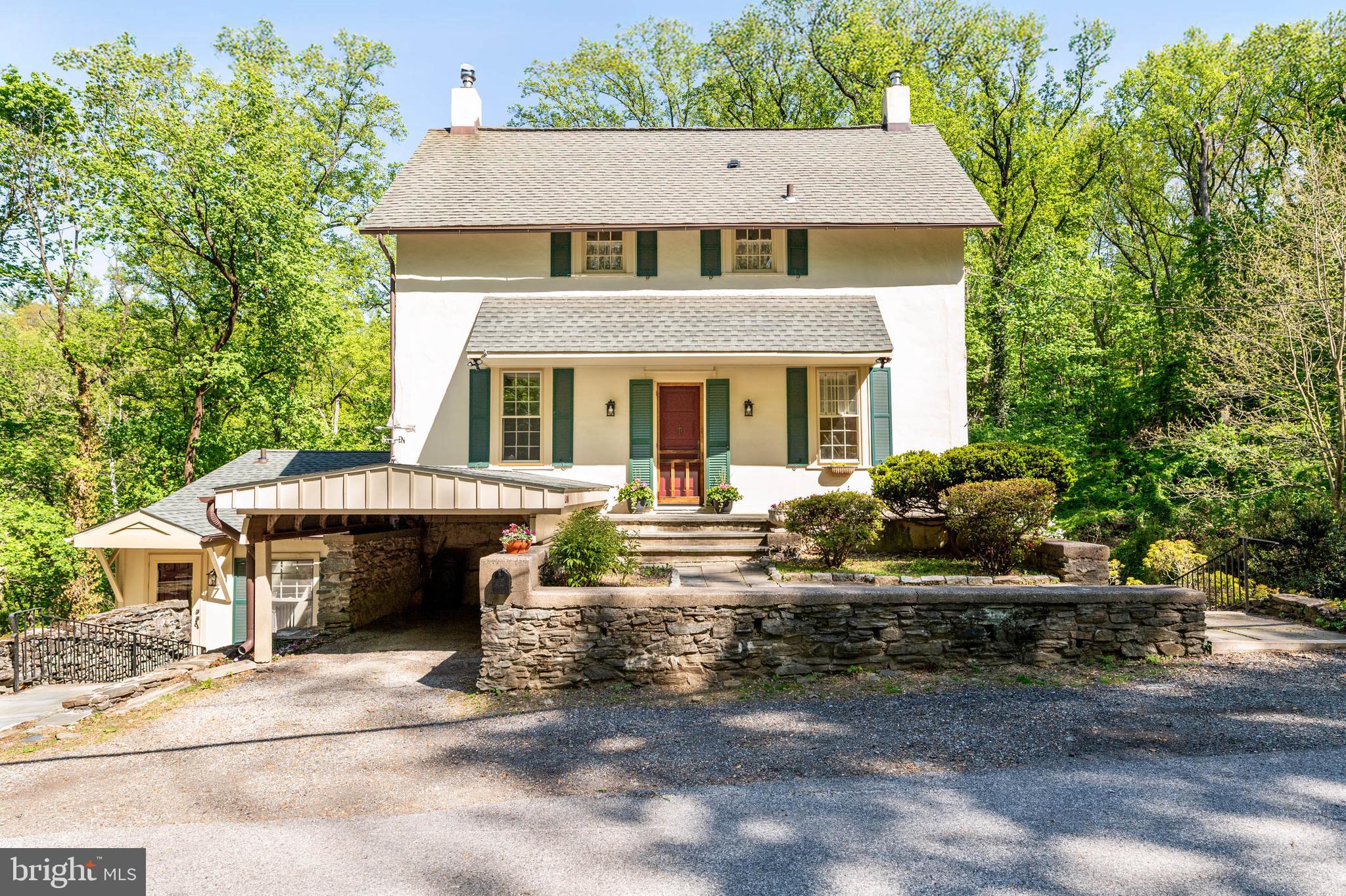 Nestled privately in a park-like setting, this enchanting 1800s colonial farmhouse is a peaceful retreat, seamlessly blending historic warmth with modern updates. Featuring 3 bedrooms and 2.5 bathrooms, 2 great options are available to enter the home. The upper level front door opens to the older historic section of the house, a living room with wood-burning stove, dry bar and loft style office or den with built-in bookshelves and large closet. Upstairs you will find two additional bedrooms and a newly renovated full tiled bathroom with glass shower stall.
The second entrance, in the 1990’s addition, features a cozy breakfast nook. The newly renovated kitchen, the heart of the home, opens to a warm dining area featuring built-in glass cabinets and windows. Enjoy morning coffee in the charming sunroom surrounded by original stone walls with a door to the back deck. A main floor bedroom with full bath, can also be used as a living room overlooking the large yard, woodlands and creek below.  
The lower level has a fully finished family room with a dutch door that opens to the rear yard and a large picture window offering great views.  The other half of the lower level is unfinished with 1/4 bath, laundry, storage,  utilities and another entrance to the rear yard.
Located in Lower Merion School District and just a short drive to the charming village of Gladwyne, Philadelphia Country Club and Riverbend Environmental Education Center. 
Perfectly positioned for both commuters and nature lovers, this home offers quick access to 76, I-476, regional rails  and is surrounded by premier riding trails, hiking trails, bike paths, and community parks. The house is adjacent to “Woodmont”, a 75 acre national historic landmark that is operated and owned by the Palace Mission Inc.