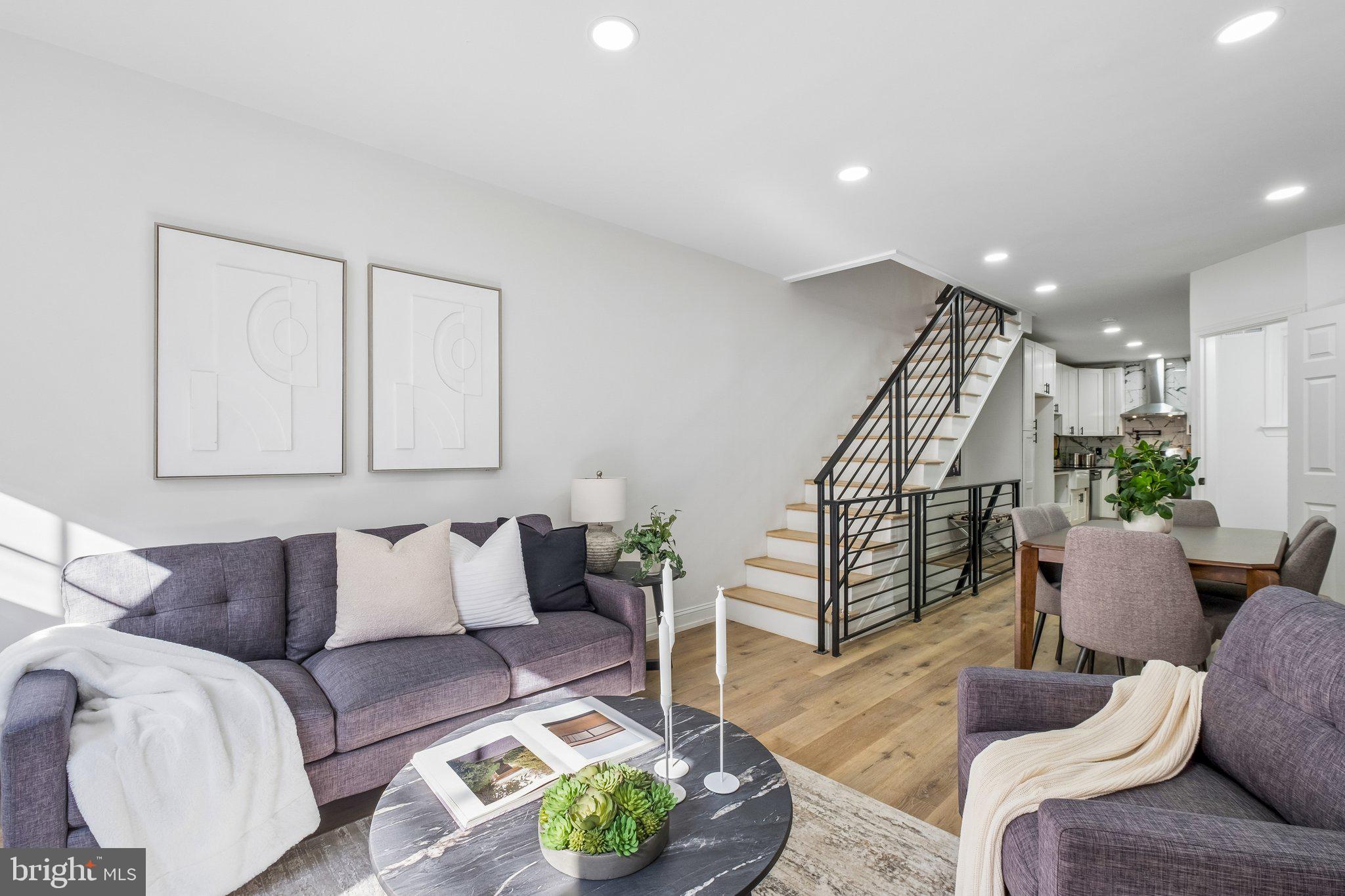 Situated in the heart of Brewerytown, this newly renovated home offers a thoughtfully designed modern layout that balances sleek contemporary finishes with everyday comfort. Step through the front door into a bright, open living room characterized by wood laminate flooring and a custom millwork accent wall, anchored by an elegant electric fireplace.
The living space transitions seamlessly into the dining area, with a conveniently located powder room positioned just before the kitchen. Serving as the natural hub of the home, the kitchen is outfitted with brand-new shaker cabinetry, including a full-length pantry, granite countertops, and a classic ceramic tile backsplash. High-end finishes, such as a farmhouse sink and stainless steel gas range, complete the space. From here, sliding glass doors lead to a newly built deck overlooking a lush backyard enclosed by a brand-new privacy fence, perfect for outdoor entertaining.
Upstairs, the rear bedroom is filled with natural light from windows on two sides. A centrally located hallway bathroom serves this level, featuring modern fixtures, detailed tile work, and integrated shelving for linens and storage. The primary suite is positioned at the front of the home, offering a generous layout with a substantial closet and an en-suite bathroom equipped with a large vanity and a contemporary walk-in shower.
For additional flexibility, the fully finished lower level provides a versatile space for a home office, gym, or secondary living area. This level also includes a dedicated laundry setup and a separate rear storage room to accommodate all your needs.
Ideally located just blocks from local favorites like Crime and Punishment Brewing Co., Green Eggs Cafe, and the various shops along Girard Avenue, this home offers easy access to the scenic trails of Fairmount Park and the Philadelphia Museum of Art. Whether you are commuting via nearby public transit or accessing I-76 and Kelly Drive, this location perfectly balances vibrant neighborhood culture with effortless accessibility. Schedule your tour today! DOWN PAYMENT ASSISTANCE PROGRAMS EXIST FOR THIS! Reach out for more information.