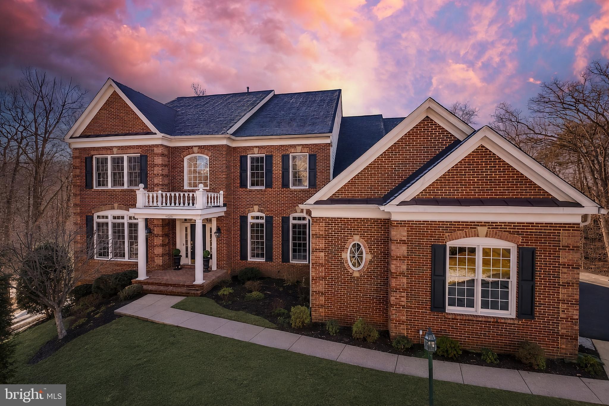 Set on nearly an acre of private, wooded grounds with direct access to the sand and pebble beach of Goose Creek, this stately brick Colonial offers a rare pairing of setting and scale in sought after Lansdowne on the Potomac. Nearly 7,000 beautifully appointed square feet span three finished levels, with seven bedrooms, six full and one half baths, and over $250,000 in improvements completed within the past five years, including a remodeled kitchen, new flooring throughout, and a more open flow on every level. A two-story foyer opens to the formal living and dining rooms, and French doors reveal a main level office with views of the trees. Elegant wainscoting trails past a hall powder bath toward the airy fireplace family room and a sunroom filled with natural light. The gourmet eat-in kitchen showcases a large breakfast bar island, high-end stainless steel appliances, a built-in workspace, and an attached butler's pantry with wine fridge, all brightened by coordinated new lighting that continues through the breakfast area and dining room. A mudroom with access to the three car garage, a second powder bath, and a spacious laundry room with a newly created large pantry complete the main level. Upstairs, five bedrooms include the primary suite with a bay window sitting area and a wet bar for morning coffee without leaving your room. Its expanded walk-in closet was created by combining two closets into one, and the primary bath features dual vanities, a step-in shower, and a soaking tub with wooded views. Four additional bedrooms offer custom designed closets, two with remote controlled blackout blinds. The walk-out lower level adds two more bedrooms, two full baths, an updated theater room, bonus rooms ready for a gym or storage, and a multipurpose rec room with a built-in bar opening to the screened porch and yard. Outside, two Trex decks, the refreshed screened porch, and a stone patio with outdoor fireplace take in the lush surroundings, framed by meticulous landscaping. In total, the owners have invested more than $250,000 here since 2021. Columns were removed and walls opened on all three levels, flooring was replaced throughout with hardwood on the upper two levels and luxury vinyl below, and the stairs and banisters were refinished. The kitchen remodel was joined by updated appliances, including the washer, dryer, dishwasher, gas range, and basement wine cooler. Even the finer details were addressed, from repainted trims, crown moldings, doors, and main level ceilings and walls to modernized hardware, a smart thermostat, and improved landscaping. All of this sits within the coveted community of Lansdowne on the Potomac, where residents enjoy indoor and outdoor pools, a fitness center, sport courts, playgrounds, a ballroom and business center, and a kayak and canoe launch into Goose Creek, plus the adjoining Potomac Heritage Trail. Just next door, the Lansdowne Resort offers 45 holes of championship golf designed by Robert Trent Jones and Greg Norman, with golf and social memberships available. Route 7, Lansdowne Town Center, the Village at Leesburg, One Loudoun, and Historic Downtown Leesburg are minutes away, and Dulles International Airport is roughly 17 minutes from your door. Private, polished, and thoroughly updated, this is a home that lives as gracefully as its setting suggests.
