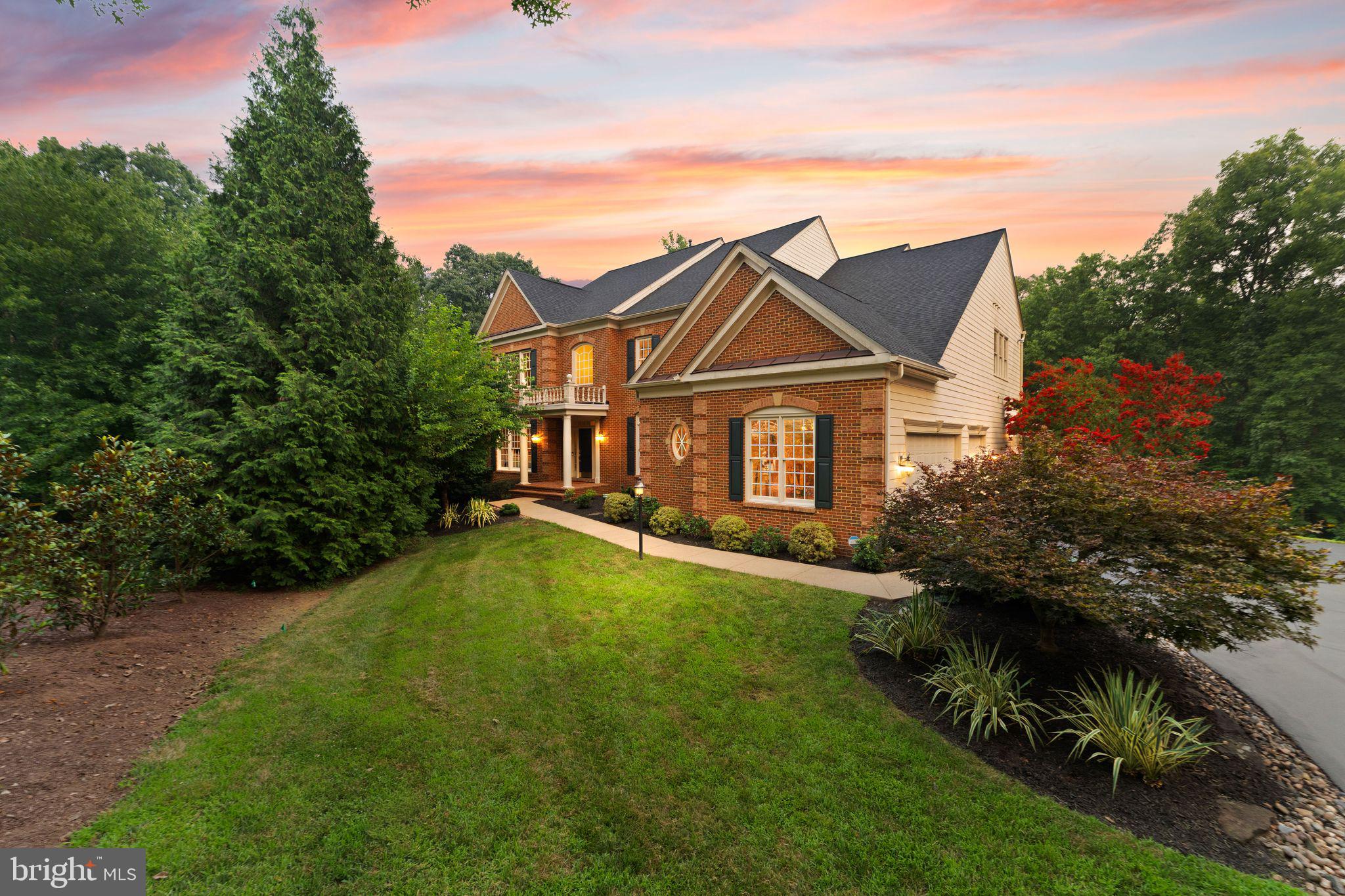 Open House Sunday July 19th 2pm - 4pm**Set on nearly an acre of private, wooded grounds with direct access to the sand and pebble beach of Goose Creek, this stately brick Colonial offers a rare pairing of setting and scale in sought after Lansdowne on the Potomac. Nearly 7,000 beautifully appointed square feet span three finished levels, with seven bedrooms, six full and one half baths, and over $250,000 in improvements completed within the past five years, including a remodeled kitchen, new flooring throughout, and a more open flow on every level. A two-story foyer opens to the formal living and dining rooms, and French doors reveal a main level office with views of the trees. Elegant wainscoting trails past a hall powder bath toward the airy fireplace family room and a sunroom filled with natural light. The gourmet eat-in kitchen showcases a large breakfast bar island, high-end stainless steel appliances, a built-in workspace, and an attached butler's pantry with wine fridge, all brightened by coordinated new lighting that continues through the breakfast area and dining room. A mudroom with access to the three car garage, a second powder bath, and a spacious laundry room with a newly created large pantry complete the main level. Upstairs, five bedrooms include the primary suite with a bay window sitting area and a wet bar for morning coffee without leaving your room. Its expanded walk-in closet was created by combining two closets into one, and the primary bath features dual vanities, a step-in shower, and a soaking tub with wooded views. Four additional bedrooms offer custom designed closets, two with remote controlled blackout blinds. The walk-out lower level adds two more bedrooms, two full baths, an updated theater room, bonus rooms ready for a gym or storage, and a multipurpose rec room with a built-in bar opening to the screened porch and yard. Outside, two Trex decks, the refreshed screened porch, and a stone patio with outdoor fireplace take in the lush surroundings, framed by meticulous landscaping. In total, the owners have invested more than $250,000 here since 2021. Columns were removed and walls opened on all three levels, flooring was replaced throughout with hardwood on the upper two levels and luxury vinyl below, and the stairs and banisters were refinished. The kitchen remodel was joined by updated appliances, including the washer, dryer, dishwasher, gas range, and basement wine cooler. Even the finer details were addressed, from repainted trims, crown moldings, doors, and main level ceilings and walls to modernized hardware, a smart thermostat, and improved landscaping. All of this sits within the coveted community of Lansdowne on the Potomac, where residents enjoy indoor and outdoor pools, a fitness center, sport courts, playgrounds, a ballroom and business center, and a kayak and canoe launch into Goose Creek, plus the adjoining Potomac Heritage Trail and two professionally designed golf courses at the neighboring Lansdowne Resort. Route 7, Lansdowne Town Center, the Village at Leesburg, One Loudoun, and Historic Downtown Leesburg are minutes away, and Dulles International Airport is roughly 17 minutes from your door. Private, polished, and thoroughly updated, this is a home that lives as gracefully as its setting suggests.