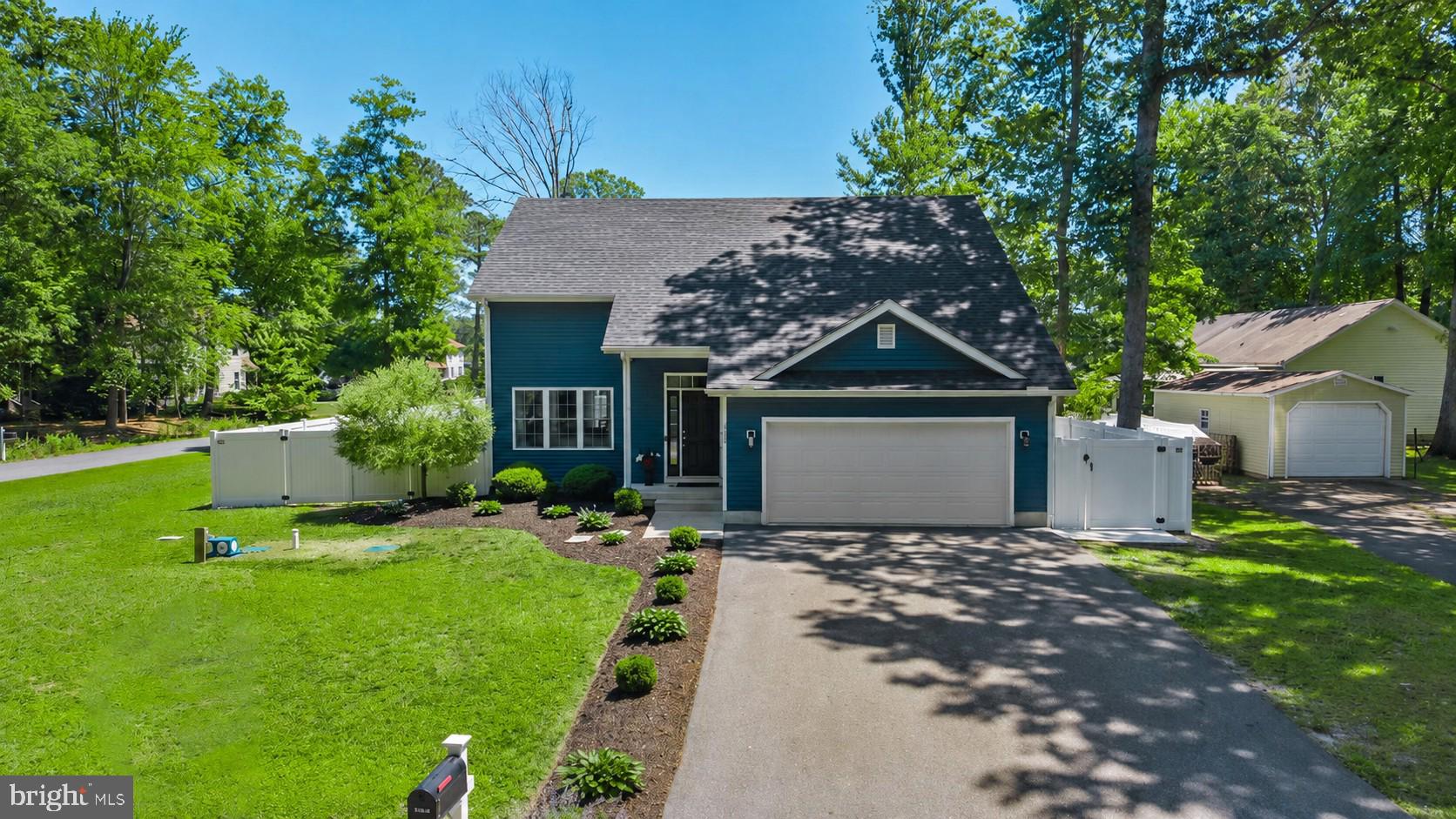 30828 Trails End in a peaceful waterfront community. Low taxes and located in sought after Lord Baltimore elementary school zone. From the moment you arrive, this beautifully maintained home captures your attention with its striking navy-and-white exterior, pristine landscaping, expanded asphalt driveway, updated exterior lighting, and exceptional curb appeal. Situated on a spacious corner lot, every detail reflects the care and pride of ownership that has gone into making this property truly move-in ready. Step inside and discover a bright, freshly painted interior where abundant natural light, soaring ceilings, and a crisp coastal color palette create an atmosphere that feels both welcoming and relaxing. The open-concept floor plan is designed for everyday comfort and effortless entertaining, seamlessly connecting the living room, dining area, and kitchen. At the heart of the home, the beautifully appointed kitchen features crisp white 42-inch cabinetry, gleaming granite countertops, stainless steel appliances, and a center island with breakfast bar seating. A recently renovated pantry adds both style and functionality, providing excellent organization and storage while keeping the kitchen beautifully uncluttered. The main-level primary suite offers a peaceful retreat filled with natural light and features a spacious walk-in closet and private ensuite bath with dual vanities and a tub-shower combination. Updated lighting and mirrors in the bathrooms enhance the home's fresh, modern appeal. Upstairs, three generously sized guest bedrooms provide comfortable accommodations for family and friends, along with a well-appointed hall bath and convenient upper-level laundry room. Updated interior lighting and ceiling fans throughout the home further enhance both comfort and style.
Outdoor living is equally impressive. Sliding doors off the dining area lead to an expanded patio and walkway designed for gathering, grilling, and enjoying Delaware's coastal seasons. The fully fenced backyard offers privacy and plenty of room for a private pool, featuring raised garden beds, underground drainage improvements, and an enclosed outdoor shower, perfect after a day spent at the beach, on the bay, or exploring the nearby waterways.  
Blackwater Village embraces the coastal lifestyle. Just steps from the home, one of the community's kayak and paddleboard launch areas provides easy access to the scenic river as it winds its way toward the bay. Residents enjoy a playground, picnic areas, fishing and crabbing docks, peaceful walking and biking opportunities, beautiful sunset views, low HOA fees, and direct access to the outdoor recreation that makes coastal Delaware so special. Ideally located near Holts Landing State Park, local dining, shopping, and the area's renowned beach resorts, this exceptional property offers the perfect combination of comfort, convenience, and coastal adventure.