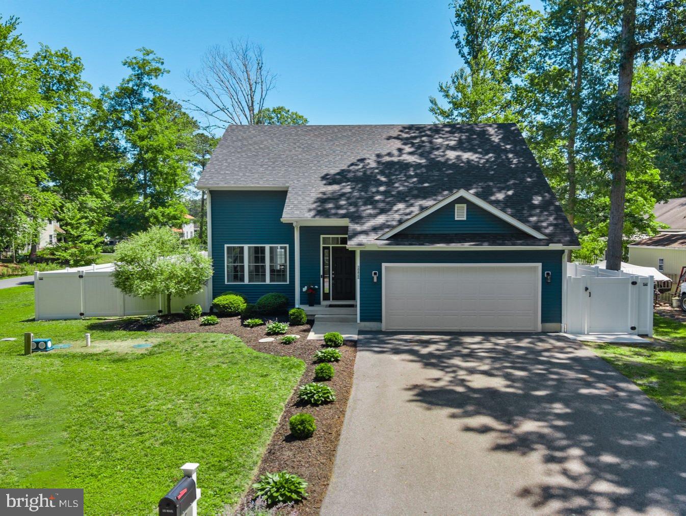 30828 Trails End in a peaceful waterfront community. Low taxes and located in sought after Lord Baltimore elementary school zone. From the moment you arrive, this beautifully maintained home captures your attention with its striking navy-and-white exterior, pristine landscaping, expanded asphalt driveway, updated exterior lighting, and exceptional curb appeal. Situated on a spacious corner lot, every detail reflects the care and pride of ownership that has gone into making this property truly move-in ready. Step inside and discover a bright, freshly painted interior where abundant natural light, soaring ceilings, and a crisp coastal color palette create an atmosphere that feels both welcoming and relaxing. The open-concept floor plan is designed for everyday comfort and effortless entertaining, seamlessly connecting the living room, dining area, and kitchen. At the heart of the home, the beautifully appointed kitchen features crisp white 42-inch cabinetry, gleaming granite countertops, stainless steel appliances, and a center island with breakfast bar seating. A recently renovated pantry adds both style and functionality, providing excellent organization and storage while keeping the kitchen beautifully uncluttered. The main-level primary suite offers a peaceful retreat filled with natural light and features a spacious walk-in closet and private ensuite bath with dual vanities and a tub-shower combination. Updated lighting and mirrors in the bathrooms enhance the home's fresh, modern appeal. Upstairs, three generously sized guest bedrooms provide comfortable accommodations for family and friends, along with a well-appointed hall bath and convenient upper-level laundry room. Updated interior lighting and ceiling fans throughout the home further enhance both comfort and style.
Outdoor living is equally impressive. Sliding doors off the dining area lead to an expanded patio and walkway designed for gathering, grilling, and enjoying Delaware's coastal seasons. The fully fenced backyard offers privacy and plenty of room for a private pool, featuring raised garden beds, underground drainage improvements, and an enclosed outdoor shower, perfect after a day spent at the beach, on the bay, or exploring the nearby waterways.  
Blackwater Village embraces the coastal lifestyle. Just steps from the home, one of the community's kayak and paddleboard launch areas provides easy access to the scenic river as it winds its way toward the bay. Residents enjoy a playground, picnic areas, fishing and crabbing docks, peaceful walking and biking opportunities, beautiful sunset views, low HOA fees, and direct access to the outdoor recreation that makes coastal Delaware so special. Ideally located near Holts Landing State Park, local dining, shopping, and the area's renowned beach resorts, this exceptional property offers the perfect combination of comfort, convenience, and coastal adventure.