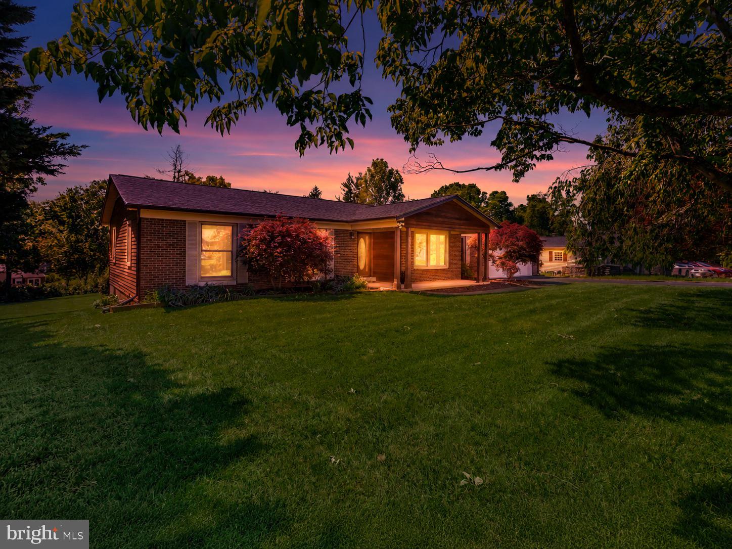 Nestled in a quiet neighborhood surrounded by mature trees and natural beauty, this beautifully updated two-level rambler offers the perfect blend of comfort, functionality, and one-level living. Featuring an open and airy floor plan with large windows throughout, the home is filled with abundant natural light and warm hardwood floors that extend across the main level living spaces.

The main level offers three spacious bedrooms and two and a half bathrooms, creating an ideal layout for everyday living. The inviting family room flows seamlessly into a bright bonus sunroom, providing the perfect place to relax and enjoy peaceful views of the backyard. The open kitchen design makes entertaining easy, while the adjoining oversized laundry area offers generous counter space, a convenient half bath, and direct access to the rear Trex deck.

Step outside to your own private outdoor retreat. Designed for entertaining and enjoying nature, the backyard features a gazebo, professionally maintained fenced pool, expansive landscaped yard, and exceptional privacy provided by the surrounding trees. Whether hosting guests or enjoying a quiet evening outdoors, this setting is truly special.

The lower level expands the home’s versatility with an additional primary bedroom suite complete with an en suite bath and ample closet space. A separate den provides flexible space for a potential fifth bedroom, home office, workout room, or guest area.

This home has been thoughtfully updated with a new roof, gutters, fascia and rake boards, fresh interior paint, new carpeting, newer windows, newer washer and dryer, and an updated main bathroom. The pool has also been professionally maintained with a new pump and new Polaris vacuum motor already installed for peace of mind.

Offering space, privacy, and numerous updates in a serene setting, this exceptional home is ready to welcome its next owners.
