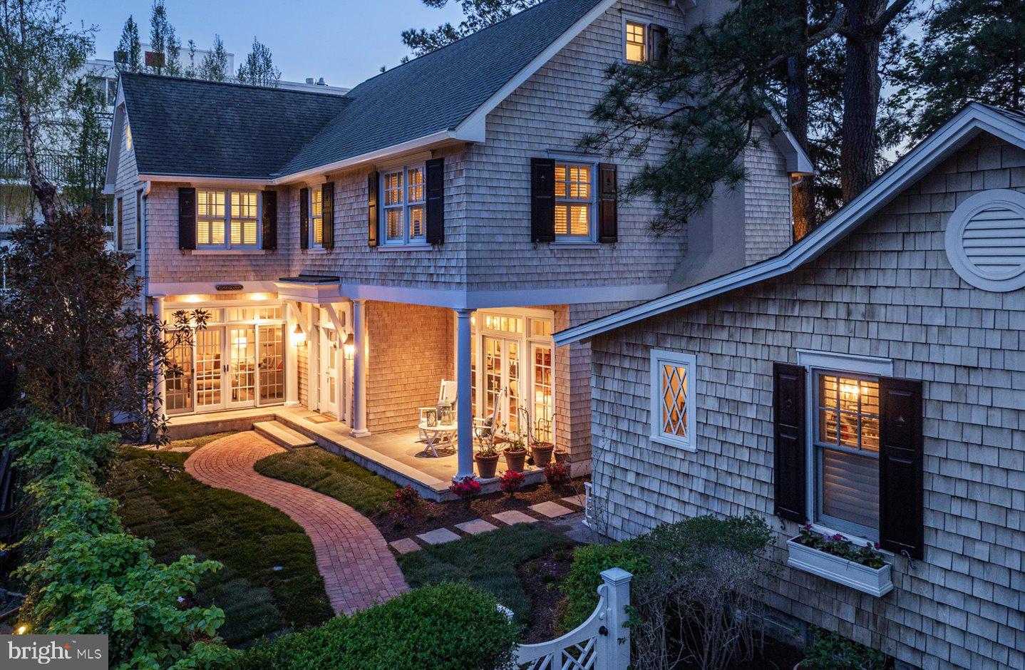 Welcome to the essence of casual coastal charm and versatility in the heart of “The Pines” neighborhood of downtown Rehoboth Beach! Nestled on a serene 50 x 100 parcel just one block north Rehoboth Avenue, this unique offering presents a blend of classic Nantucket style and modern functionality in two distinct cedar shingle style dwellings. Twice featured on the Rehoboth Art League house tour in 2008 and 2016, being sold fully furnished. The main attraction is an impressive three-story residence known as “Tucked Away,” featuring 4 spacious bedrooms and 3.5 bathrooms. From the inviting facade adorned with crisp white trim and charcoal black shutters to its roomy interior, every detail says welcome home. Step inside to discover a thoughtfully designed floor plan that seamlessly integrates comfortable living spaces with timeless architectural elements. Walnut and bluestone floors, coffered ceilings, custom built-ins, and classic moldings throughout create an atmosphere of warmth and sophistication. The heart of the home lies in its gourmet kitchen, complete with stainless appliances, custom cabinetry, honed granite counters, and a tiger maple island perfect for entertaining. Adjacent dining and multiple living areas offer effortless flow for hosting intimate dinners or lively gatherings. Level two is host to the bright and spacious primary suite with vaulted ceilings and exposed beams, a comfortable sitting area, ensuite tile bath, and custom closet. On this level, you will also find a laundry room, custom tiled hall bath with a jetted tub and separate shower, and 2 additional guest bedrooms. The 4th bedroom, loft entertainment area, and 3rd full bath can be found on the third level. The appeal of this property doesn’t end there. An additional 2 bedroom, 2 bath historic cottage, built circa 1930, is also nestled on this property. Renovated in 2005, this charming cottage offers additional accommodation options or income potential with its own separate entrance and amenities. Whether utilized as a guest suite, home office or rental opportunity, this versatile space adds value and flexibility to the property. This unique property offers easy access to Grove Park, the Rehoboth Farmers’ Market, vibrant dining, shopping, and entertainment scene, as well as its pristine beaches. With two rental licenses, the potential for investment income is excellent, making this a rare opportunity not to be missed!