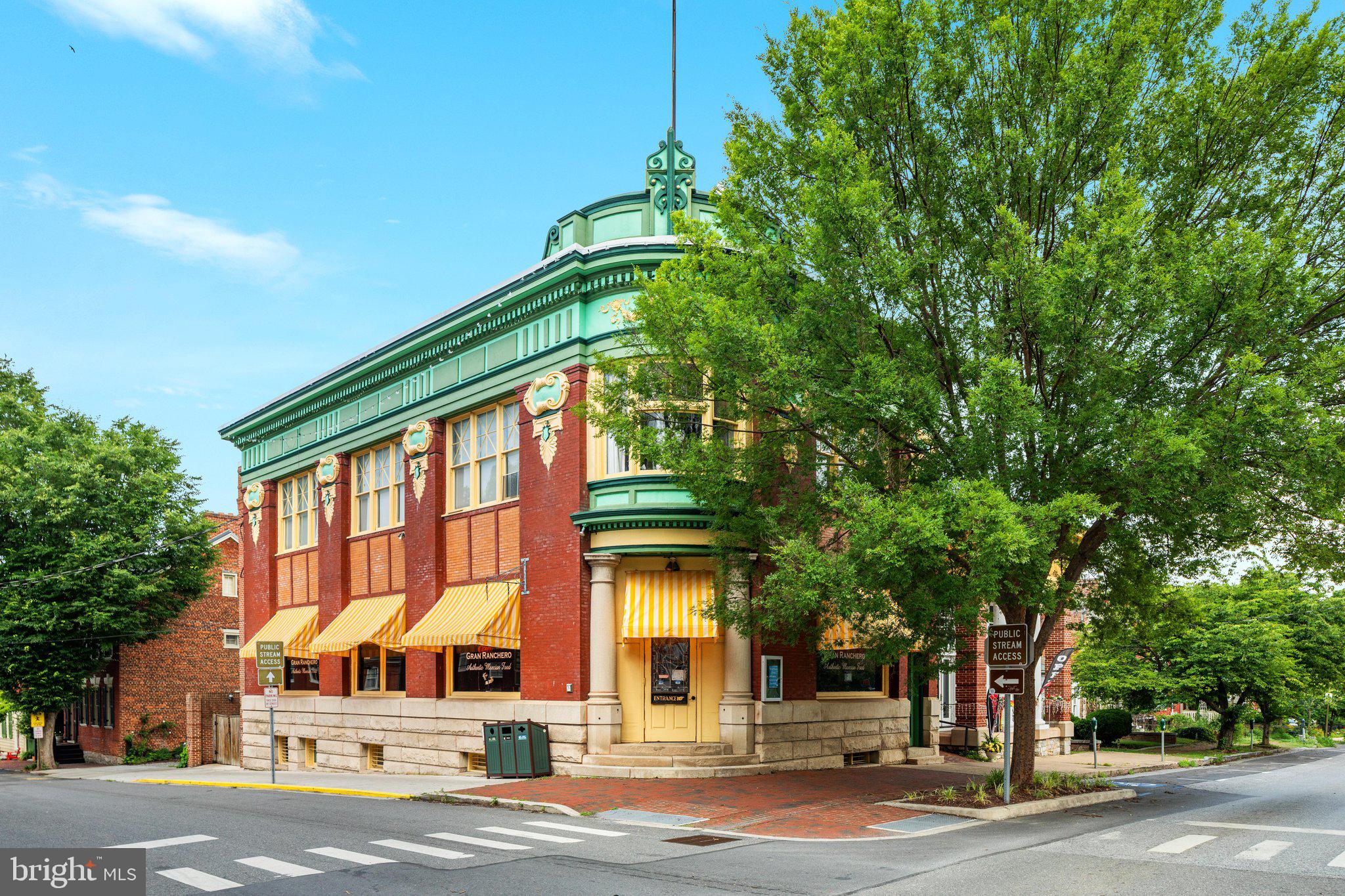An exceptional opportunity to own one of historic Shepherdstown’s most iconic mixed-use commercial properties in the heart of West Virginia’s oldest town!  Prominently situated on a .173-acre commercially zoned corner parcel along East German Street, this landmark building, originally constructed in 1906, offers an impressive 9,000 + total square feet of versatile space, blending timeless architectural character with outstanding investment potential.

Spanning approximately 9,000 square feet, the property presents a versatile layout well-suited for a variety of commercial, hospitality, retail, office, or mixed-use opportunities.  The main level features expansive restaurant and pub space with large storefront windows, prominent street frontage, inviting dining areas, bar service, and a commercial infrastructure established presence along one of the town’s most traveled corridors create exceptional exposure for any business venture.  An upper-level leased commercial business unit offers the added benefit of supplemental rental income, also creating an attractive investment opportunity.

Steeped in history and prominently positioned within Shepherdstown’s vibrant downtown business district, the property also enjoys exceptional visibility and year-round pedestrian traffic from residents, visitors, tourists, and the Shepherd University community.  Surrounded by locally owned boutiques, acclaimed restaurants, galleries, entertainment venues, historical landmarks, and just moments from the Potomac River, this location places your investment at the center of one of the region’s most charming and thriving destinations.

Whether preserving its legacy as a celebrated dining and gathering place, transforming it into a boutique hospitality destination, or capitalizing on its mixed-use potential, the possibilities are remarkable. Properties of this size, prominence, and historic significance rarely become available in downtown Shepherdstown!
