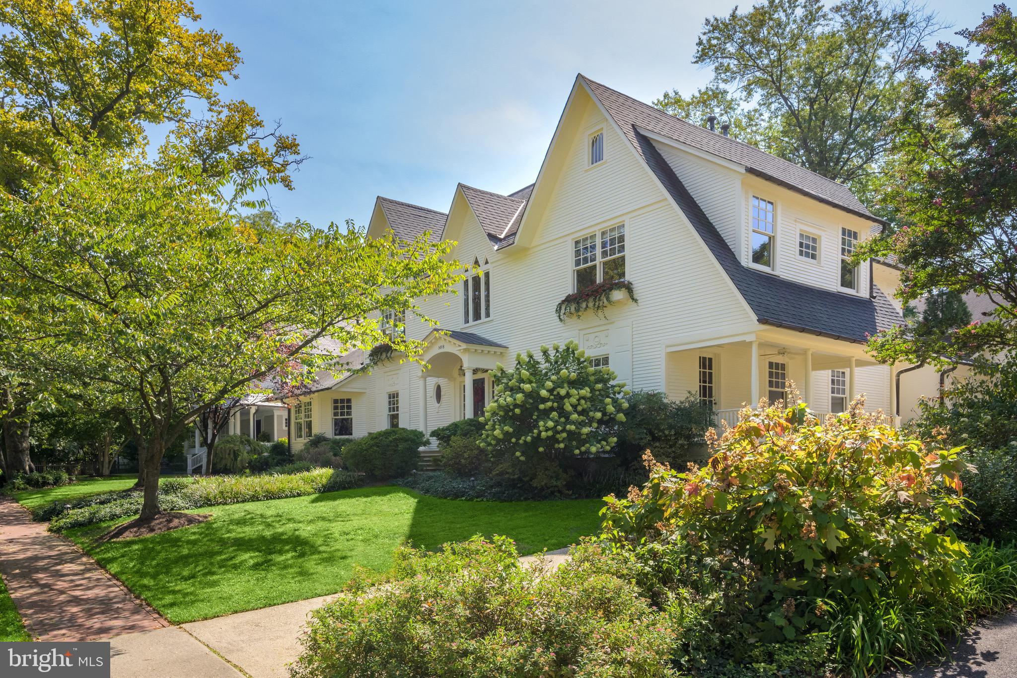 An iconic Chevy Chase masterpiece, originally constructed in 1906 and painstakingly renovated by renowned architect John Samperton for his own family, 8 East Melrose Street bears historical significance and exudes class. Located on one of the most coveted addresses in the Village, the residence has a distinct Victorian-Gothic style while evoking cues from America’s great summer estates in Nantucket. Prominently sited on a double 0.29 acre lot with unmistakable curb appeal, the home has hosted numerous glamorous events within Washington’s scene, showcasing its timeless social significance. A rare offering, this property has only changed hands a handful of times in the last century, meticulously preserved over the years as a testament to a bygone era of permanence in craftsmanship.

A brick walkway leads to the central portico, introducing a layout suited for both grand entertaining and intimate family living. Effortless flow, vaulted ceilings, abundant storage, six bedrooms, four and a half bathrooms, and an attached two car garage offer a precious combination of practicality and luxury. 8 East Melrose has been meticulously crafted with hand selected materials: original white oak floors inlaid with walnut, leaded and stained glass windows, extensive millwork with rosette-embedded crown moldings, and authentic architectural details. Formal spaces exude moments from the Golden Age of entertaining, with whimsical Ionic columns, balusters, roaring fireplaces surrounded by hand-carved mantels, accent lighting, and ¾ height chair rail molding establishing a sense of occasion. Yet, informal spaces embody the practicality demanded of casual contemporary lifestyles, exemplified by the chef’s kitchen, whose modern cabinetry integrates state-of-the-art Viking, SubZero, and Bosch appliances. Likewise, an expansive mudroom includes built-in lockers and accesses both the front porch as well as garage with EV connection points. Upstairs, the primary suite’s wood burning fireplace introduces a warmth to the space. Triple walk-in closets and a spa bath with twin vanities, steam shower, and jetted soaking tub complete the oasis. Three secondary bedrooms, two baths, a convenient laundry room, and a breathtaking private office with cathedral ceiling overlooking the treetops through stained glass complete the picture. The lower level features a large recreation room with built-in shelving, full bath, and an additional bedroom with a walk-up to the home’s exterior. 

The expansive property has full southern exposure, is surrounded by mature trees, and has been professionally landscaped for the utmost privacy and year-round color. The lot’s elevated position offers a sweeping view of the neighborhood and a private, rear lawn.

Equidistant between the revered Chevy Chase Club and the District Line, the location is convenient to verdant parks, trendy shopping, acclaimed eateries, leading schools, and the city. Blending traditional beauty, historical significance, and modern luxury—8 East Melrose is a cherished estate ready for its next chapter.