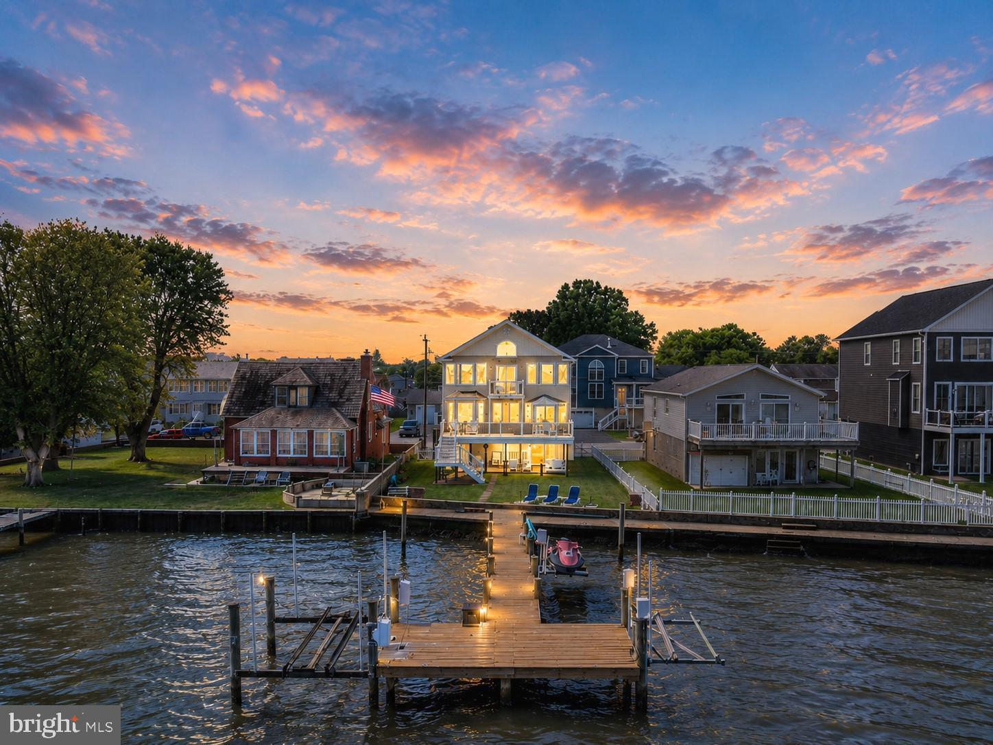**Welcome to 7112 River Drive Road, a meticulously maintained waterfront retreat offering nearly 4,000 square feet of total space and breathtaking panoramic views that take center stage from nearly every room. Combining luxury updates, exceptional boating amenities, and thoughtfully designed indoor and outdoor living spaces, this extraordinary home delivers the ultimate lifestyle.
From the moment you step inside, soaring ceilings, gleaming hardwood floors, and expansive windows draw your attention to the spectacular water views. Natural light fills the home, while the family room offers a cozy gas fireplace and built-in surround sound, creating an inviting setting for both everyday living and entertaining.
The beautifully updated kitchen features Quartz countertops, recessed lighting, abundant cabinetry, an undermount sink, center island with storage, and Samsung Smart appliances installed in 2021, including a tablet-style refrigerator with water dispenser and ice maker. A 2026 kitchen addition created a charming breakfast nook where you can enjoy your morning coffee while taking in the tranquil waterfront scenery. Andersen sliding glass doors with built-in blinds, installed in 2023, open to a maintenance-free walk-down composite deck, seamlessly blending indoor and outdoor living.
The main level also includes two bedrooms, a full bath with porcelain tub from the original home, a laundry room with Smart LG washer, second washer (SideKick), and Smart dryer.
Upstairs, double doors lead to the luxurious primary suite, where oversized windows continue to showcase stunning waterfront views. This spacious retreat offers vaulted ceilings, brand-new carpet, a sitting area, a custom walk-in closet, and a private composite deck overlooking the water. The newly remodeled spa-inspired en-suite bath features a walk-in shower, freestanding soaking tub, double vanity, Smart LED mirror, Bluetooth exhaust fan, and a Smart toilet with bidet, heated seat, and auto-flush functions.
A previously unfinished attic has been transformed into a fourth bedroom/bonus room with new carpet, recessed lighting, updated electrical, built-in storage, and closet.
Outside, boating enthusiasts will appreciate the impressive 80-foot T-pier with water, electric, 30-amp shore power, two boat lifts (12,500 lb. w/Gem remote and 3,500 lb.), and a 1,500 lb. jet ski lift. 3 ft MLW and a hard sandy bottom, this property is ideal for boating, fishing, and water recreation. On clear days, the sellers note you can see the Eastern Shore from the end of the pier.
Additional features include concrete bulkhead, under-deck drainage, two sheds with maintenance-free platforms, a Polywood swing overlooking the water, a two-car attached garage, tankless gas water heater, Nest thermostat, generator hookup, fresh interior paint (2023), sealed driveway (2024), new shutters, front door, chandeliers, Hunter ceiling fans, and updated exterior lighting. The pier was redecked in 2020 with new end caps and hurricane straps added in 2024.
Flood insurance is only $565 annually. 
This exceptional property offers easy access to waterfront dining, fishing, and endless boating adventures. Experience the unmatched beauty of waterfront living and schedule your private tour today.
