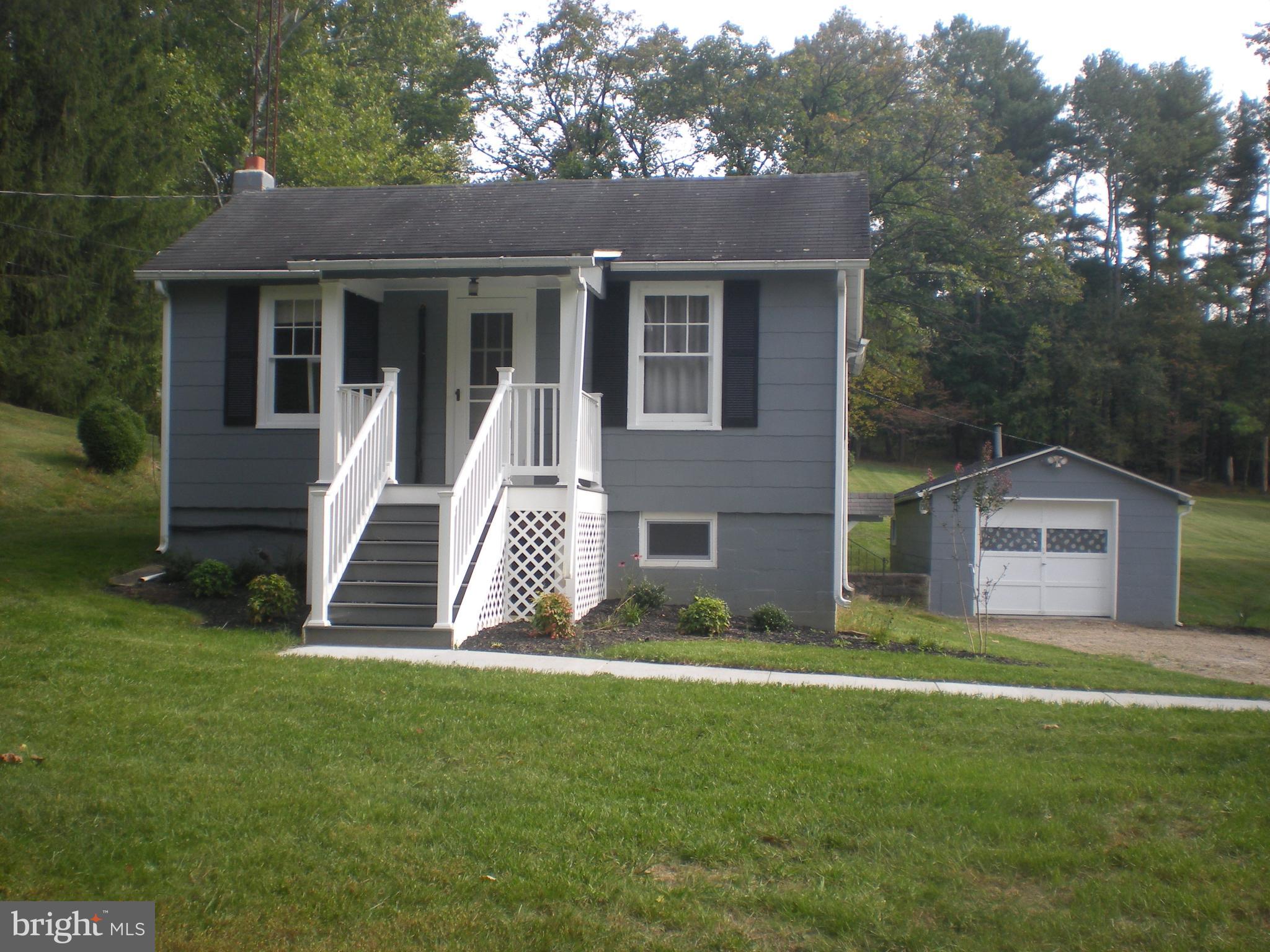 NEW SEPTIC WITH DEEP TRENCH INSTALLED.  (READY FOR 6 bedrooms)    One Level living with some updates.  Exterior has been painted, new sidewalk installed and New Front Trex Porch and railings.  Some new windows.   One car garage included.   Rough-in in basement for future bath.   Warm oil heat and mini split for Cooling.   Correct lot size is 1.72  Acres   Great Location !!    Only minutes to 795.    Just waiting for your interior updates.