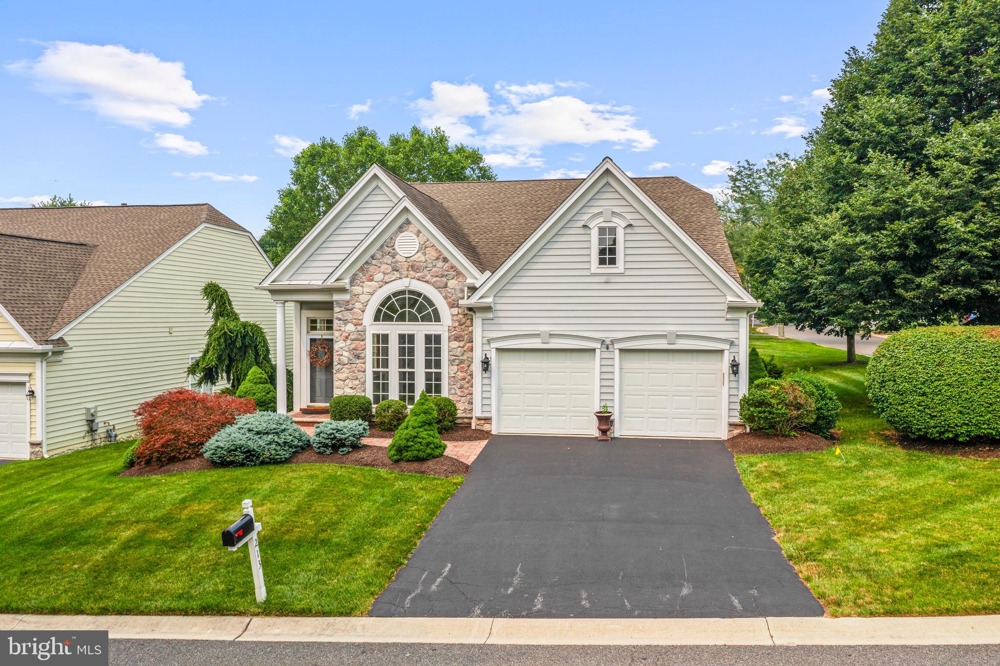 Discover exceptional low-maintenance living in Traditions at Longwood, Kennett Square’s premier 55+ community, ideally located just minutes from the world-renowned Longwood Gardens and the charming shops, restaurants, and cultural attractions of downtown Kennett Square. This beautifully enhanced residence showcases a thoughtful collection of owner improvements, combining elegance, comfort, and modern convenience for today’s discerning buyer. From the moment you enter, you’ll appreciate the refined details throughout, including hardwood flooring, sophisticated crown moldings, and beautifully appointed living spaces designed for both everyday enjoyment and effortless entertaining. The gourmet-inspired kitchen serves as the centerpiece of the home, featuring a spacious island, inviting breakfast area, and modern appliances including a built-in microwave, self-cleaning oven, and dishwasher. The kitchen flows seamlessly into the family room, where a gas fireplace with glass doors creates a warm and inviting atmosphere for relaxing evenings with family and friends. The first-floor primary suite provides a private retreat with a luxurious en-suite bath featuring a soaking tub, while a convenient main-level laundry room and powder room add to the home's exceptional functionality. The upper level offers two additional bedrooms, a full bath, a comfortable sitting area, a private office/den, and a floored attic providing abundant storage space. Step outside to enjoy your private outdoor retreat featuring a recently added Trex and vinyl deck, perfect for morning coffee or evening gatherings while taking in the beautifully landscaped surroundings. The extensive list of improvements includes a whole-house generator for peace of mind, new central air conditioning (2025), numerous ceiling fans, replacement windows, an Andersen sliding glass door, newer driveway, stone paver walkway, and a professionally finished epoxy garage floor. Beyond the home itself, enjoy the unmatched lifestyle offered at Traditions at Longwood, a Gold Star-designated 55+ community featuring a clubhouse, outdoor pool, fitness center, tennis courts, pickleball, bocce, game room, and a vibrant calendar of social activities. With lawn maintenance and snow removal included, this is the opportunity to enjoy the very best of Chester County living—where luxury, convenience, and community come together beautifully.