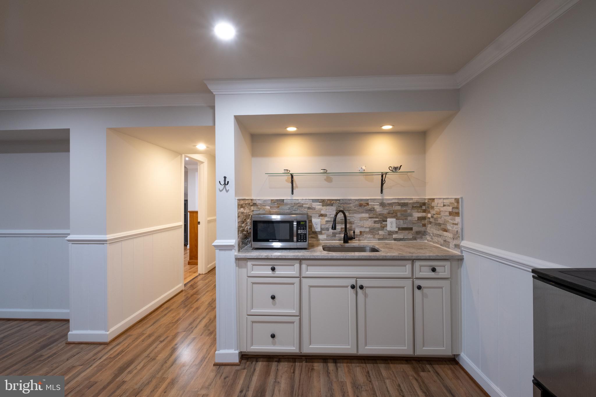 *** RENT INCLUDES WIFI and ALL UTILITIES!! *** BEAUTIFULLY MAINTAINED, LIGHT-FILLED, and optional partially furnished BASEMENT APARTMENT IMMEDIATELY AVAILABLE - 600 sq ft, 1 bedroom, 1 full bath, living room with dining area, and a kitchenette equipped with an electric double burner, microwave, and refrigerator. Washer/dryer in unit. Quiet neighborhood with a private stone path to a separate entrance. Parking is available in the driveway. Walking distance to shops and dining, less than 10 minutes from GMU, and a short commute to Vienna Metro Station. **NO PETS**