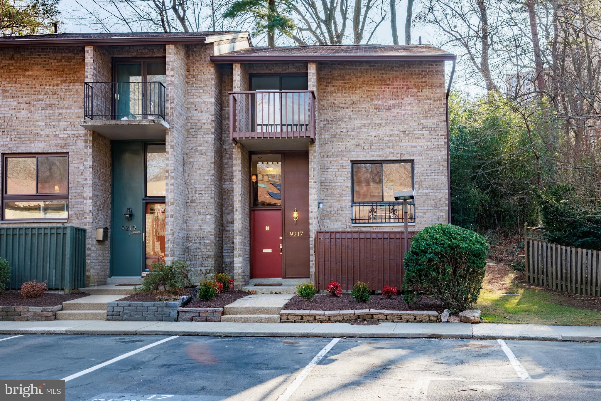 ** Significant Price Improvement!** Welcome to 9217 Three Oaks Drive, a beautifully updated all-brick end-unit townhome backing to peaceful wooded views and located just steps from Sligo Creek Park with its extensive trail system. This home offers a quiet and private setting while remaining conveniently close to the Beltway, Downtown Silver Spring, and future Purple Line access.

The interior has been freshly painted throughout and features hardwood floors across the main level. The entry includes a convenient coat closet and opens to a dining area that flows into a spacious living room with a fireplace. Sliding glass doors lead to a private rear deck overlooking trees, creating an ideal indoor outdoor living space.

The kitchen has been updated with 42 inch cabinetry, granite countertops, stainless steel appliances, and a large window that brings in abundant natural light.

Upstairs, the primary bedroom includes a private balcony, walk in closet, and an updated en-suite bathroom. Two additional bedrooms and a hall bathroom complete the upper level.

The lower level offers excellent additional living space with a recreation or family room, a bedroom, a full bathroom, and a laundry and utility room, making it ideal for guests or flexible living arrangements.

Parking is easy and conveniently located in the lot directly out front, with one assigned space and another unassigned spot. 

The neighborhood features a community pool and playground, adding to the appeal of this well located and thoughtfully maintained home!