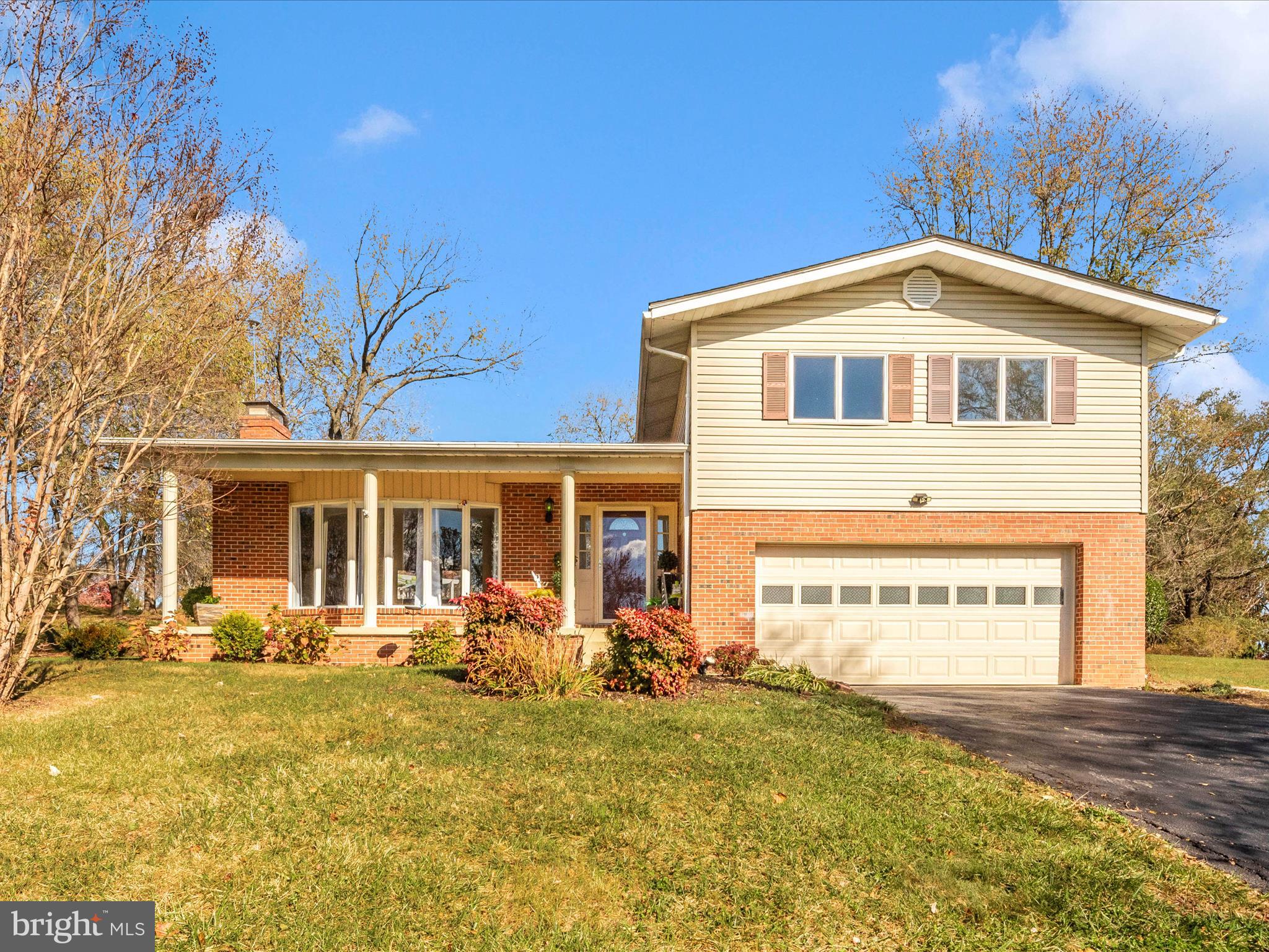 Welcome to this charming 4-level split home in a well-loved, established neighborhood! Sitting gracefully above the road, this home captures your attention with its pretty front yard and inviting front porch, offering a warm welcome the moment you arrive.

Inside, the foyer opens to a spacious main level with gleaming hardwood floors that flow through the large living room, featuring a bright bay window and a cozy fireplace, and throughout the main level. This open area connects seamlessly to the dining room, creating an ideal space for entertaining or family gatherings. The kitchen, tucked away at the rear of the home, is updated with granite countertops and newer appliances and offers access to a large deck overlooking the private backyard—a perfect spot for outdoor dining and relaxation.

Upstairs, you'll find a beautifully renovated full bath at the top of the stairs, along with two generously sized spare bedrooms. The primary bedroom is also on this level and includes its own updated bath with a walk-in shower, offering a private retreat.

Downstairs, from the foyer, discover a cozy and flexible space with another fireplace—ideal for an office, family room, or even guest quarters. This level also features a third full bath and provides access to the attached 2-car garage.

The lowest level offers added versatility with a laundry room, a large storage area, and an expansive family/rec room complete with yet another fireplace, perfect for entertaining, relaxing, or creating a game room.

Lovingly maintained by a long-time owner, this home radiates warmth and charm and is sure to delight even the most discerning buyers.