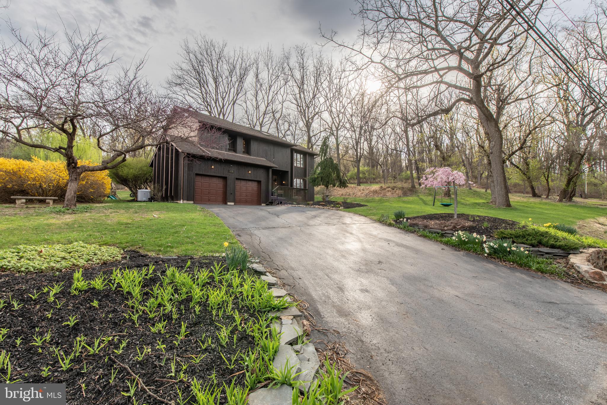 Welcome to your serene contemporary retreat at 1338 Santee Mill Road—nestled on a quiet, tree-lined 0.69-acre lot just minutes from vibrant downtown Bethlehem! This architecturally striking 4-bedroom, 2.5-bath home offers a seamless blend of modern style and natural beauty, delivering the privacy, comfort, and lifestyle you’ve been searching for. Step inside to an airy, light-filled layout highlighted by vaulted ceilings, skylights, and expansive windows that bathe the space in sunshine. A dramatic two-story foyer welcomes you into the formal dining room, sunken living room, and a bright family room featuring a stunning wood-accented wood-burning fireplace—perfect for cozy evenings. Just off the dining area, the sunroom offers the ideal spot to unwind, entertain, or enjoy a morning coffee with views of the peaceful landscape. The newly refreshed kitchen boasts stainless steel appliances, contemporary flooring, and a charming breakfast nook framed by panoramic windows, with direct access to the large back deck—perfect for al fresco dining or relaxing with nature all around. Upstairs, the spacious primary suite is a true retreat, featuring vaulted ceilings, oversized windows, and tranquil treetop views. Three additional bedrooms provide plenty of flexibility for guests, family, or a home office. Downstairs, the lower level offers unfinished space, a workshop area, and a luxurious walk-in sauna—your personal wellness escape. Outside, mature landscaping, a lush lawn, and a wooded backdrop create a sense of calm and connection to nature. Across the street, Camel's Hump Farm provides access to a community garden, outdoor yoga, and a whimsical nature playscape. Just past the community garden, which offers access to running trails and Housenick Memorial Park gives even more space to explore, run, and recharge. This isn’t just a home—it’s a lifestyle of peace, nature, and thoughtful design. Don’t miss the opportunity to make it yours.