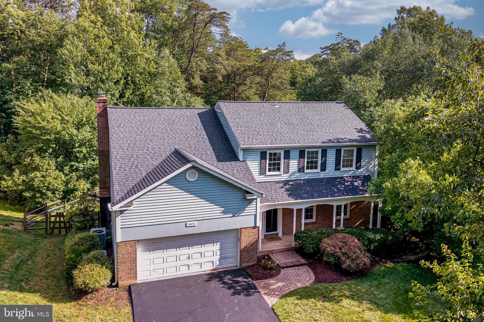 Rare opportunity to own a private woodland retreat backing directly to the W&OD Trail in one of Reston's most peaceful, low-traffic neighborhoods. Situated on a fully fenced half-acre lot, this home offers exceptional indoor-outdoor living, a highly sought-after floor plan, and an outdoor entertaining space unlike anything else in the neighborhood. 

Inside, you'll find generous living spaces, a well-appointed kitchen, and a rare upper-level layout with four spacious bedrooms and three full bathrooms upstairs, including two en suite bedrooms. With 4 bedrooms and 4.5 baths overall, there's plenty of room for family and guests.  

The standout feature is the stunning three-season room, wrapped in warm cedar and anchored by a stone wood-burning fireplace, creating the perfect space for morning coffee, quiet evenings, or year-round enjoyment of the wooded views.  

Outside, the elevated deck overlooks a backyard designed for gathering and recreation, complete with a lower-level walkout patio and dedicated spaces for game-day entertaining. Whether you're hosting friends for football, setting up cornhole and outdoor ping-pong tournaments, or enjoying an evening around the fire, this versatile outdoor living area was built for making memories. 

Updates include roof and newly paved driveway, interior paint and new carpet (all 2026). 

Enjoy direct access to miles of hiking and biking on the W&OD Trail while remaining just minutes from Reston Town Center, Reston Station, the Silver Line Metro, Tysons, the Dulles Toll Road, shopping, dining, and major commuter routes.