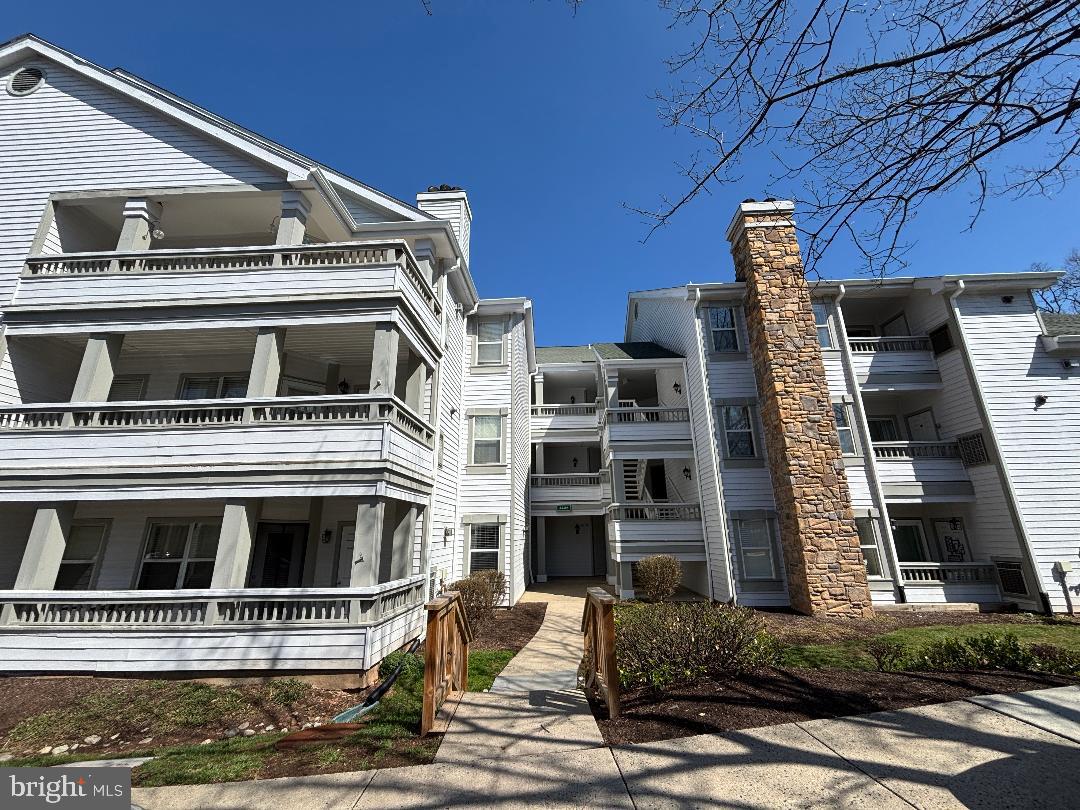 Spacious, bright, and open 2BR/2BA second-floor unit featuring separated bedrooms and a huge 24x8’ covered balcony with its own storage closet. The welcoming tile entry foyer leads to a kitchen with staggered whit oak cabinetry, stainless steel appliances, granite counters, gas cooking, breakfast bar and pantry. The luxurious living area boasts 9' ceilings, gas fireplace, while both large bedrooms offer walk-in closets and private access to updated bathrooms. The unit includes a stacked washer and dryer and plenty of storage. Located in a pet-friendly complex - one pet per unit that uses the common areas - may apply with the Board for more than one pet. Two unassigned parking spaces. Updated gas HVAC '13, water heater '20 and plush carpeting '22.  Enjoy superb condo amenities, outdoor pool, racquetball court, fitness center, clubhouse and lounge. Ideally situated across from Fair Lakes Shopping Center, restaurants and big-box stores, with easy access to I-66 and Route 50.