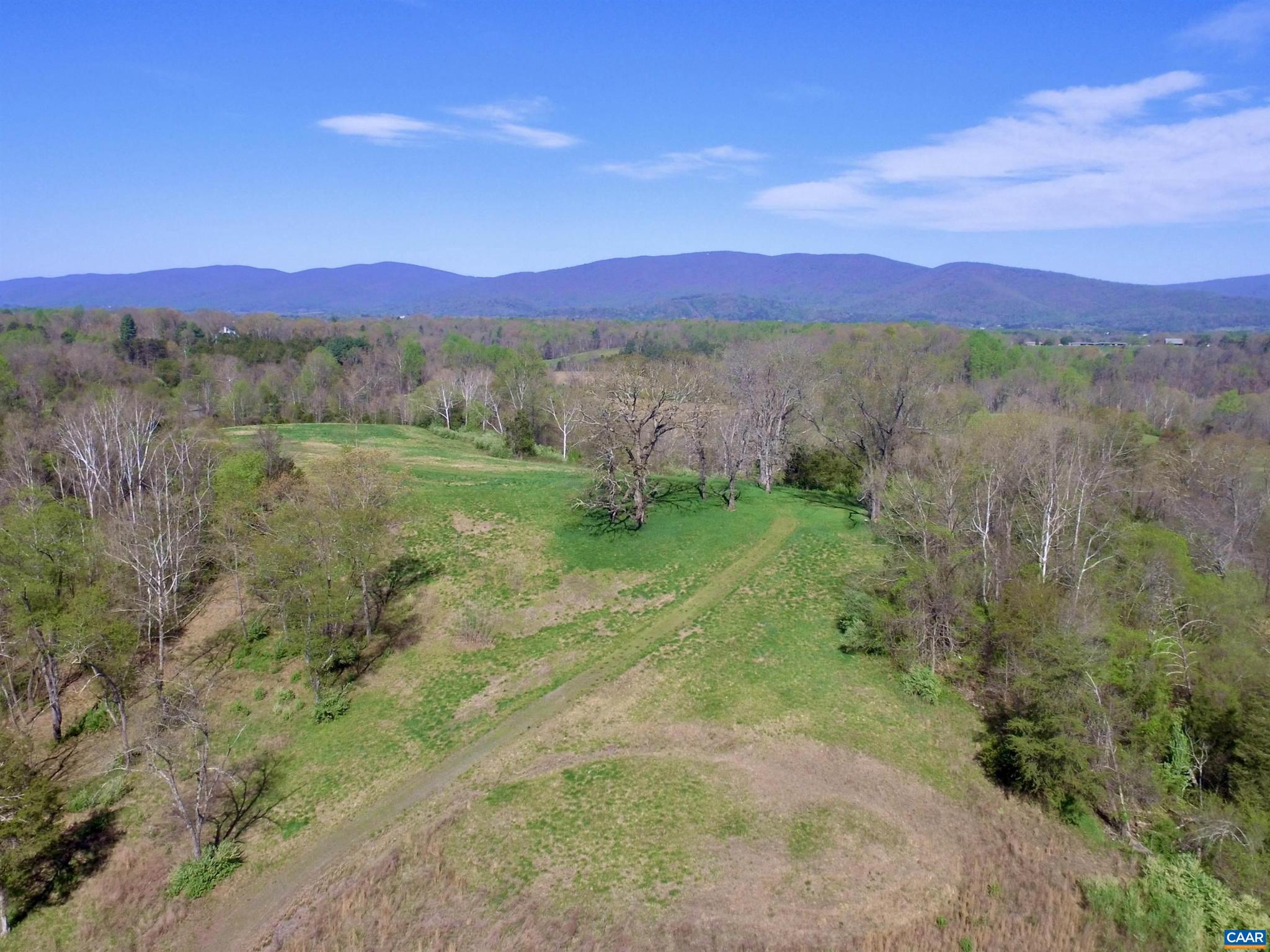 Remarkable parcel located west of Charlottesville between Ivy and Crozet with pond frontage and sweeping Blue Ridge Mountain views. This parcel retains all five development rights. Create the next great estate or investigate the potential for divisions with an approved VDOT low-volume entrance. Soil studies complete for a five-lot subdivision with engineered septic systems. This property has it all. The primary building site is on a hilltop with views in every direction. Driveway in place all the way to the large pond. Good pasture for horses or other livestock with elevated slopes for an orchard, vineyard or other agricultural pursuit. Wildlife abounds.,Gillums Point