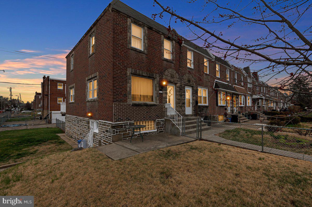 ******* OFFER DEADLINE SATURDAY  April 5, 8pm**********Welcome to this well maintained 3 bedroom, 1.5 bath, stone/brick corner property which is situated on a quiet street in the Mayfair section of NE Phila. Approaching you will immediately notice the amazing curb appeal with tasteful landscaping, plush zoysia grass that covers the fenced-in, massive front and side yard, intricate stone work around the door and window frames, and a new steel front door with beveled glass window.  Enter to find a spacious & bright living room which features hardwood flooring, an oversized picture window and side windows that allows loads of natural light throughout the entire home. The formal dining area is able to accommodate those large family gathers, includes custom crown moulding, and leads to the kitchen.  The kitchen offers plenty of chic white cabinetry, built in appliances, an abundant amount of counter top space, and access to the amazing rear deck which is ideal for relaxing and entertaining. . The second floor boasts 3 generous size bedrooms that  include a ceiling light fixtures,  closets for plenty of storage, and a updated bright white 3-piece ceramic tile hallway bathroom with updated fixtures, and  vanity. The lower level offers endless possibilities and additional finished living space to do as you please,  such as family room/office/playroom 4th bedroom, provides a rear and side egress, half bath, massive storage closet that carries into  the garage, and a separate laundry area with all the amenities. Additional features include private rear parking and plenty of on-street parking, new hot water heater 2024, amazing rear deck and much more..  Close proximity to top notch schools, all major highways, shopping, and public transportation. Make your appointment today!!