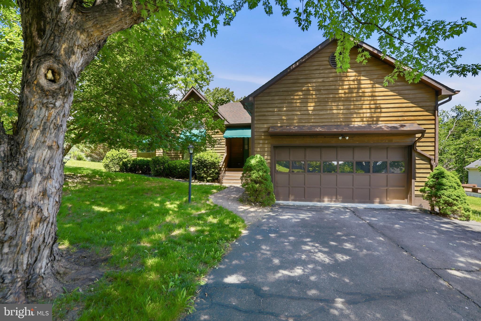 Discover the ease of one-level living in Lake Holiday, with a home that's ready for your personal touch. Situated on a beautiful, spacious lot surrounded by mature landscaping, this property offers a peaceful setting and plenty of room to enjoy the outdoors. The extended driveway provides ample parking for guests, with space to accommodate a boat so you're always ready for a day on the lake.

Inside, the freshly painted interior creates a bright, neutral backdrop for your design vision. The traditional ranch layout features a vaulted living room anchored by a wood-burning fireplace and large windows that frame views of the serene backyard. The kitchen offers Corian countertops, a new refrigerator, bar seating, a convenient desk area, and easy access to the dining space. Just beyond, a stunning screened porch invites you to relax with your morning coffee or unwind in the evening, while the adjoining deck overlooks the private backyard. The primary suite includes its own bath, and two additional bedrooms share a full hall bathroom. Conveniently located near the front gate and school parking area, this home combines comfort and accessibility with the unmatched amenities of Lake Holiday. Residents enjoy a private gated community centered around a 240-acre lake, complete with three beaches, sports courts, a dog park, walking trails, an 18-hole disc golf course, and countless other amenities and opportunities for recreation. Come vacation where you live!