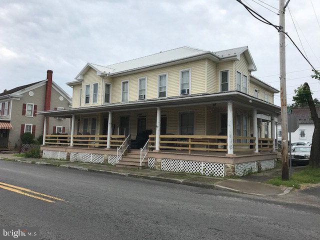 3 unit apartment house.  Needs TLC but brings in $1100 per month.  Baseboard electric with separate meters.  2 big outbuildings plus a small one.