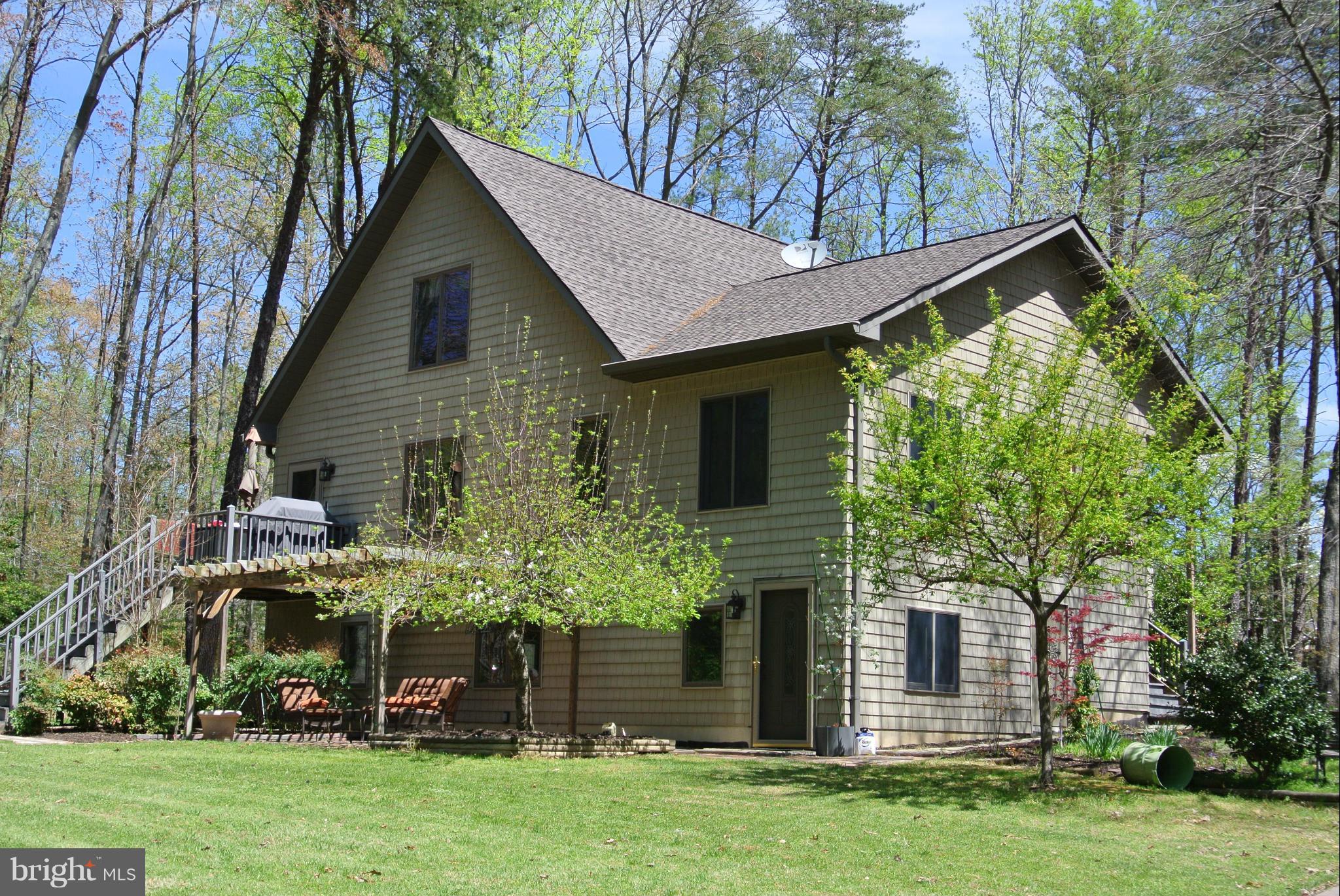 Welcome to Paradise. Large home in beautiful country setting features Bolivian Rosewood floors, upgraded kitchen, double enclosed sunrooms, fully finished basement for entertaining, & separate mudroom entrance. Relax on your patio under the pergola overseeing a gardener's delight. Bring the extra cars & toys, home features an extra 3 car garage with plenty of storage & separate paint booth.