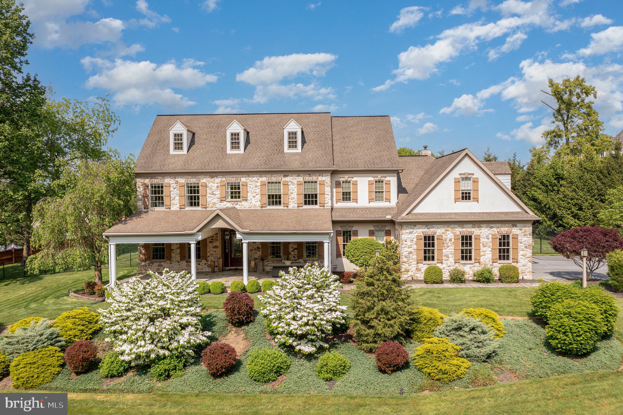 Discover your dream home nestled on 1.42 acres of private land in a serene neighborhood characterized by rolling country hills. This exquisite 5-bedroom stoned house is designed for both luxury and entertaining.  Enjoy the elegance of gorgeous hardwood floors paired with brick tile throughout this expansive home. The open floor plan features 10-foot ceilings and large molding, creating an airy and welcoming atmosphere perfect for entertaining guests. Tailored for culinary enthusiasts, the kitchen boasts custom drawers, an oversized sub zero refrigerator, convenient pot filler and an industrial oven. Immerse yourself in the pleasure of cooking in a space designed for a chef. Retreat to the comfort of the stunning oversized primary suite, ideal for unwinding with a cozy blanket and a good book. The home is adorned with interior designed drapery and brilliant lighting fixtures, adding to its bespoke charm. The finished lower level includes a living area, bathroom and a roughed-in bar, perfect for hosting events and personal enjoyment. Step outside to a spectacular backyard oasis featuring a custom gunite pool and jacuzzi, set on a beautifully stoned patio. The pool house comes complete with a built-in kitchen and a lovely fireplace, offering a perfect spot for relaxation or social gatherings. Savor peaceful mornings and evenings on the cozy wrap-around front porch, where you can enjoy stunning views of the surrounding tranquility and fresh air. Take leisurely walks to the nearby farmer for fresh eggs or enjoy the local scenery, ensuring a lifestyle of peace and simplicity. The property includes a roomy 3-car garage, catering to all your storage needs. Situated just 9 miles from Hershey Medical Center and minutes to shopping, the home offers easy access to local amenities and services. Whether you're looking to entertain or escape in your own private haven, this home offers it all.