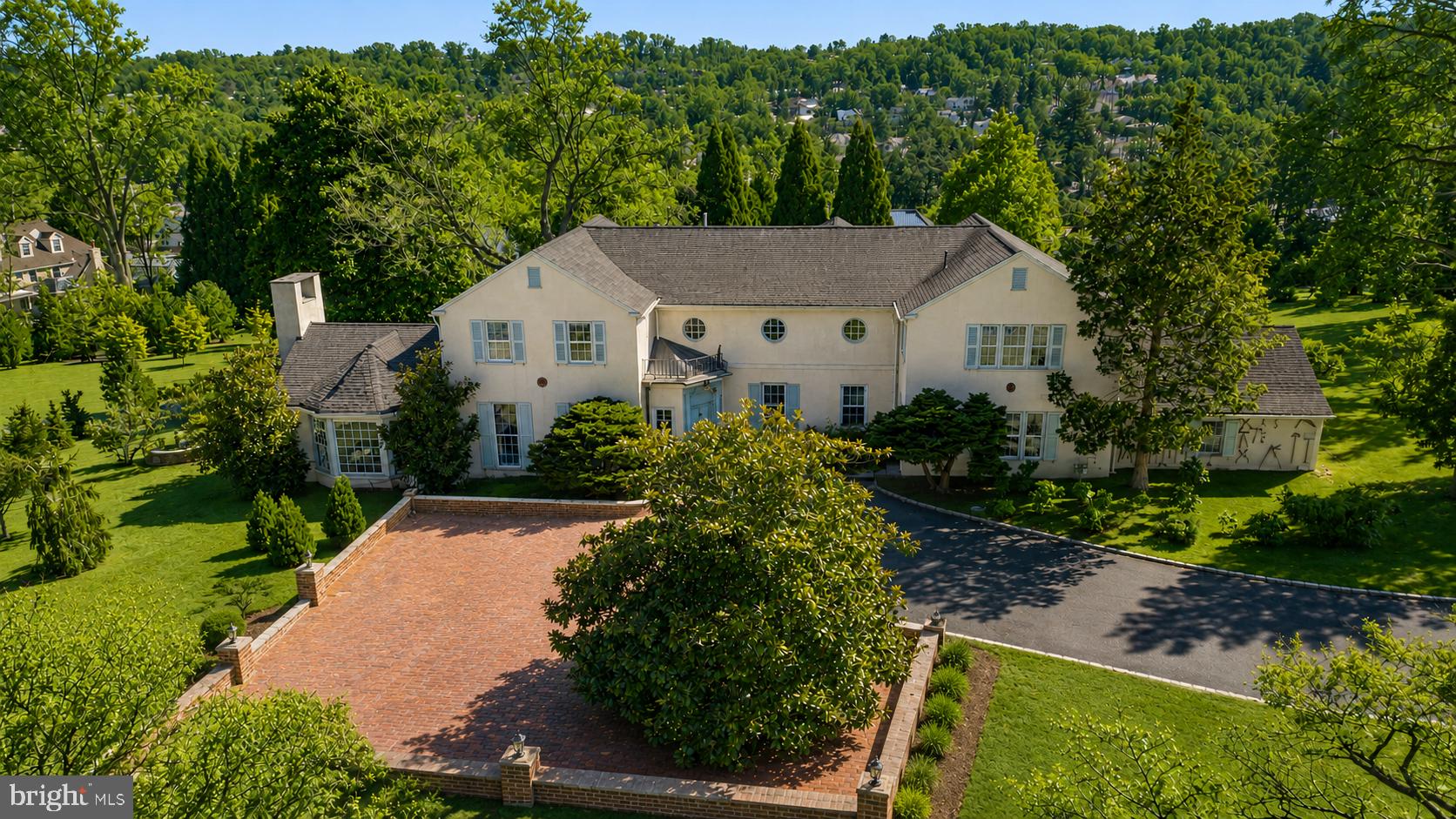 Set on nearly five acres in the heart of the Main Line, this notable 4 bedroom, 3 full and 1 half bath single family residence blends historic European craftsmanship with thoughtful modern upgrades. Originally constructed in 1930, the home offers just over 5,000 square feet of refined living space, surrounded by mature landscaping and one of the finest private conifer collections on the East Coast.

Throughout the home, hand selected, period appropriate Farrow & Ball paint colors complement rare architectural elements and museum quality finishes. Cuban mahogany and walnut paneling sourced from the renowned J.P. Morgan Library grace the sunroom, ballroom, library, dining room, stairwell and primary suite, creating a sense of timeless elegance and historical significance. The sunroom features a hidden library, adding a layer of intrigue and charm.

The kitchen was fully renovated in 2023 with custom cabinetry, a farmhouse sink, and high end appliances including an LG wall oven, LG convection microwave, LG gas cooktop, and a KitchenAid refrigerator.  A beautifully detailed mudroom showcases 16th-century English paneling from the historic Guildford Estate, originally owned by industrialist George W. Elkins, with Tudor architectural elements imported from England and meticulously reassembled by European craftsmen.

The primary suite continues the home’s remarkable story, featuring J.P. Morgan Library paneling in the bedroom and Guildford Estate paneling in the dressing room; elements that took nearly a decade to complete in their original installation. Throughout the home, exquisite 19th century doors and doorways further enhance its architectural authenticity.

Recent upgrades include new HVAC systems with programmable thermostats, plumbing and mechanical improvements by Haller Enterprises, a new septic tank, a 50-gallon water heater, and a new roof and gutters installed in October 2022. A full basement with laundry, attached garage, newly installed carport and patio provide both functionality and convenience. 

The grounds are equally impressive, featuring an exceptional collection of mature and rare trees, including Japanese maples, cryptomeria, weeping conifers, Serbian spruce, beech, and many others; creating a private arboretum like setting.

A rare opportunity to own a property where architectural history, craftsmanship, and modern comfort converge in one of the Main Line’s most desirable locations with low taxes.  Please note also listed as Land, possible subdivision allowed.  Watch the video tour to fully experience the property.
