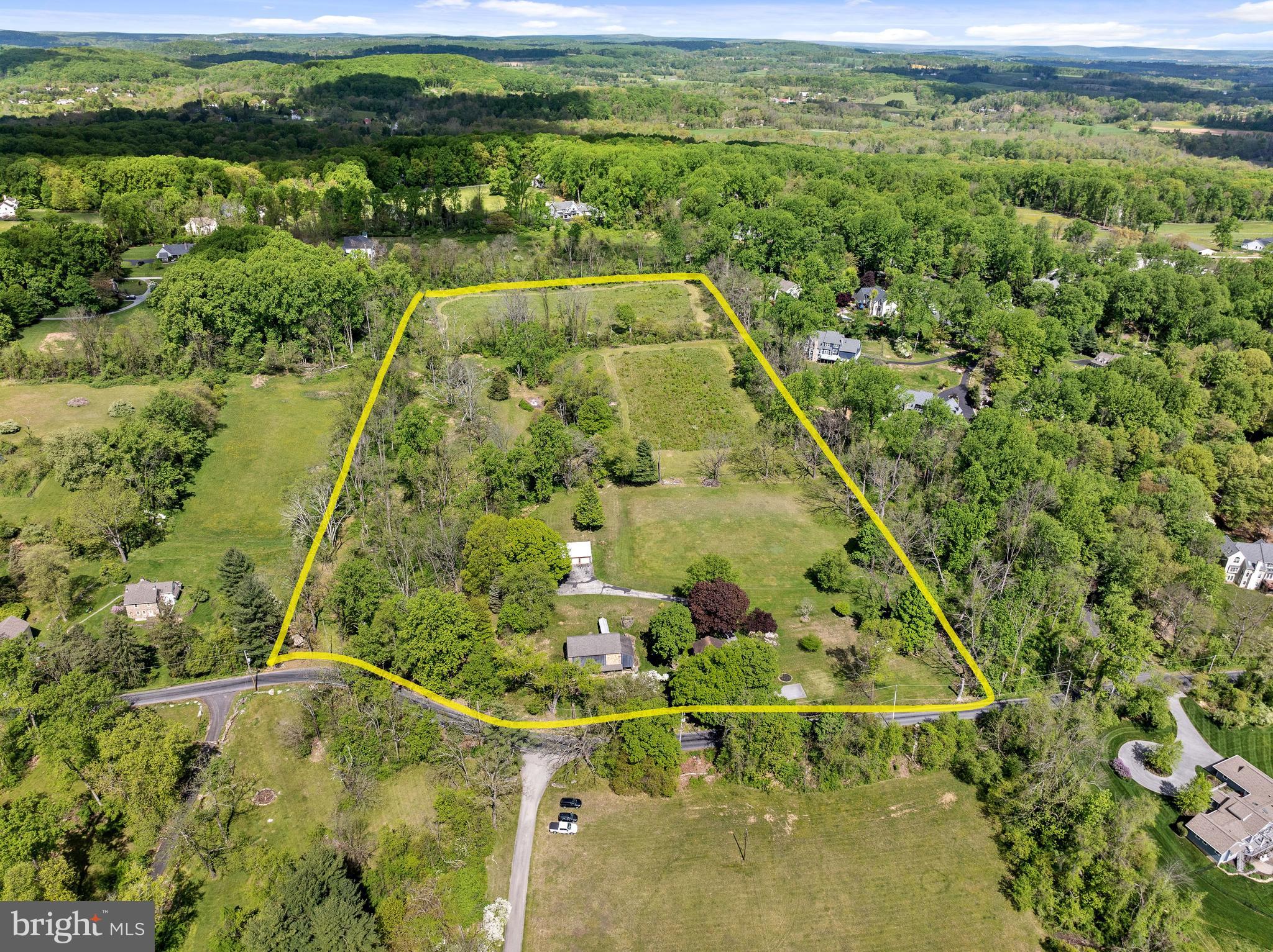 Established in 1794, Pikeland Hills Farm is located at the eastern end of Chester Springs, adjacent to Malvern and Phoenixville, and situated within the sought-after Downingtown School District. Owned by the same family for three generations, this 22-acre estate is now available for sale for the first time. Two parcels combine to create 22 acres of lush farmland, offering stunning views of protected Chester County land, including meadows, woods, the estate and barn areas, and a stone Springhouse which hosts the headwaters of a tributary that feeds into Pickering Creek. This peaceful property is proudly protected by the National Lands due to its geological importance and its proximity to the renowned Binky Lee Preserve.

The estate itself comprises the original stone home, a barn, and a large garage. Notable original features of the home include exposed stone walls, wooden beams, and brick floors. Two outdoor sitting areas are available: the covered front stone patio facing rolling open grounds in front of Indian Springs, and the side porch, providing a lovely spot to enjoy the sights and sounds of the property.

The home has been expanded, updated, and maintained to be the perfect country farmhouse. The kitchen, the heart of the home, is bright, airy, and spacious, featuring exposed wooden beam construction, exposed stone, a long kitchen island, and an eat-in dining area, making it ideal for gatherings of any size. Windows look out to the grounds and the barn. The living room features a deep windowsills, exposed beams, and a warm blend of brick and hardwood floors. Adjacent to the living room is another bright room, suitable for use as a den, office, or playroom.

The front two bedrooms on the second floor are part of the original home. Through the larger bedroom, walk-up stairs provide access to the floored attic for storage. The addition on the rear of the home hosts the spacious primary bedroom suite with a large walk-in closet, views of the grounds, and direct access to the full hall bath with a shower/tub combo and a large linen closet. The second full bath, with a stall shower, is located on the first floor.

The basement is larger than expected and has taller ceilings in the rear where the addition was built. The original hand-pumped well is preserved in the back left corner of the home as a nod to the incredible history of the property. In addition to the farmhouse, the stone and wood barn was renovated in 2012 and offers endless usage opportunities, serving as a true centerpiece of the property. The final structure is the 2-car oversized garage with pull-down stairs to access the fully floored second level for additional storage.

Thanks to the National Lands protection and Act 319, the taxes are an incredibly low $4,860 for the year. The property is zoned for Lionville Elementary and Middle Schools and Downingtown East High School, and students have the opportunity to apply to the STEM school, a world International Baccalaureate academy. Schedule a personal tour of the home and grounds to see how you can own a pristine and pure piece of Chester County grounds and history.