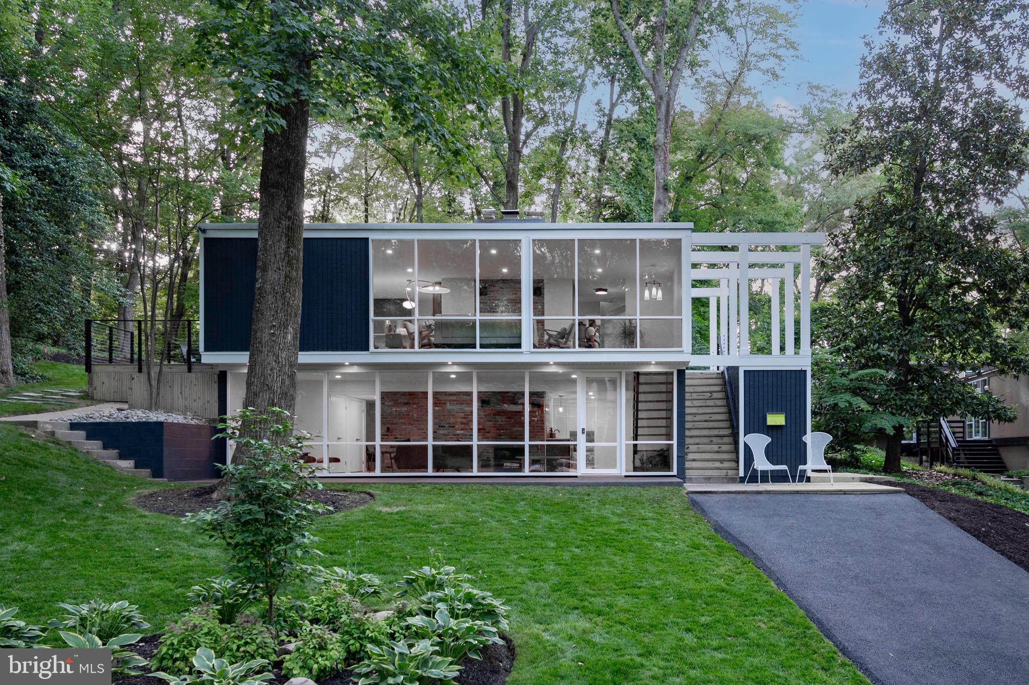 Welcome to this iconic Hollin Hills house, prominently featured on the Hollin Hills Wikipedia page. Designed by the renowned architect Charles Goodman, this two-story mid-century modern home has been completely remodeled from top to bottom, seamlessly blending vintage charm with modern amenities.

Entry addition with dramatic steps leading to the front door and ample exterior storage space.  
4 bedrooms and 3 full baths including a stunning new addition to the primary suite.  Features two walk-in closets, a wall safe, and a luxurious en suite bathroom equipped with heated floors, a bidet, dual shower heads, and a teak double vanity. Primary suite rear entry leads to a private paver patio, ideal for secluded relaxation. Light-filled living room, with wood-burning fireplace that is plumbed for gas logs. New double pane floor-to-ceiling windows offering expansive views and abundant natural light throughout the house.
Remodeled open concept kitchen with Kitchen Aid appliances, quartz counters, wine rack and breakfast bar. 
Large deck off kitchen features cable railing and provides an excellent space for entertaining guests.

Light filled lower level with exposed brick wall, wood-burning fireplace and high end wide plank engineered wood floors. Open steps with soaring walnut acoustic paneling and built-in indoor planter. Custom wet bar with beverage fridge is perfect for entertaining.  Fourth bedroom with exterior entrance and dual entry full bath makes this a perfect au-pair / in-law suite.  
Separate laundry room with refinished vintage Youngstown metal sink cabinet and stackable washer and dryer.  Finished bonus room could be theatre room, office or gym.  Loads of storage with three coat closets, and huge double storage closet with shelves 

Original features retained throughout including Goodman stair railing; a nod to the home’s architectural heritage, walls of brick adding texture and historical significance, vintage lighting preserved to maintain the mid-century modern aesthetic.  This home is a perfect blend of historical significance and modern luxury, situated in the desirable Hollin Hills community. Enjoy the charm of mid-century modern design with all the conveniences of contemporary living.